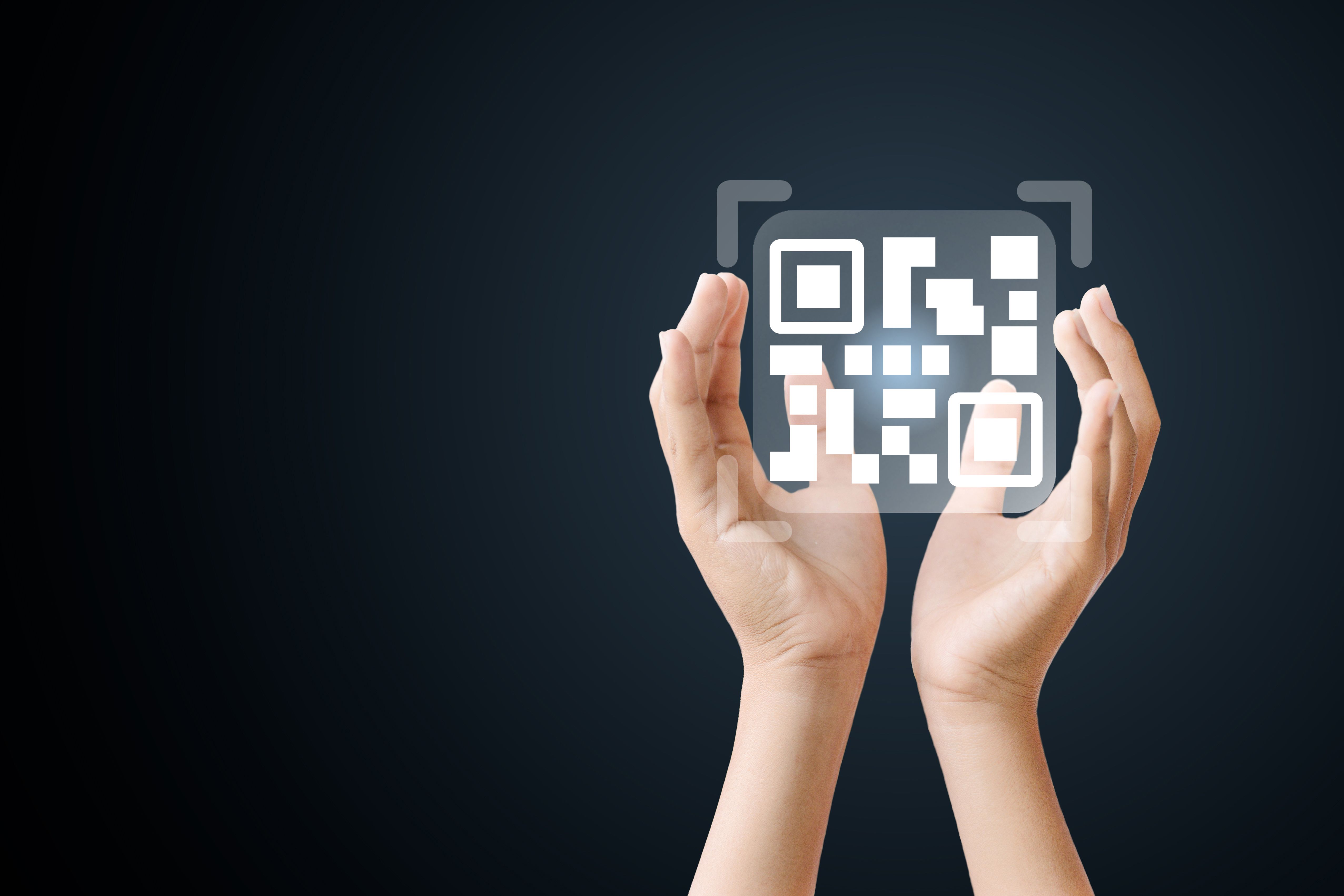 Hands holding a QR code symbol Hands holding a QR code symbol