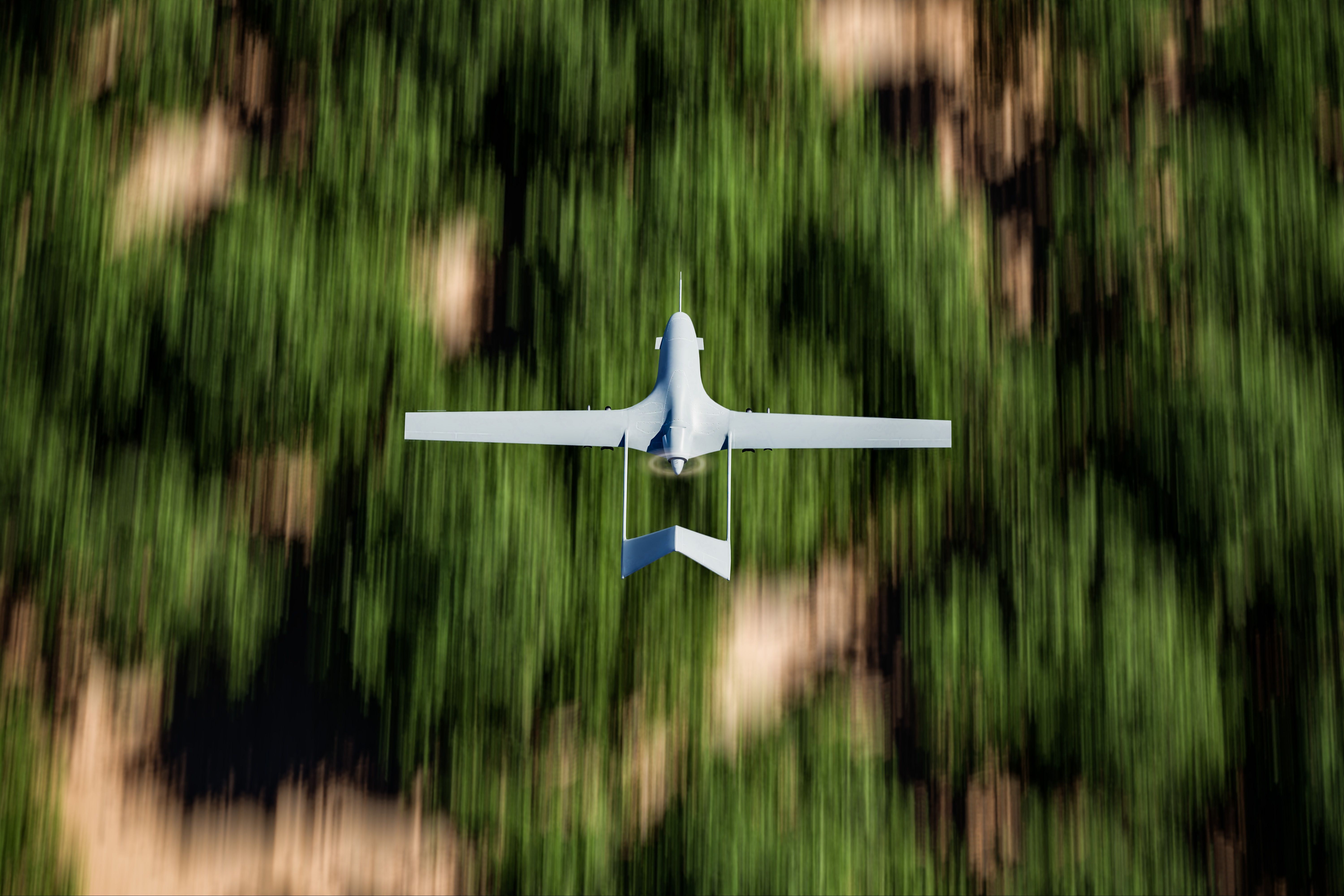 Military UAV (drone) flying over forest area