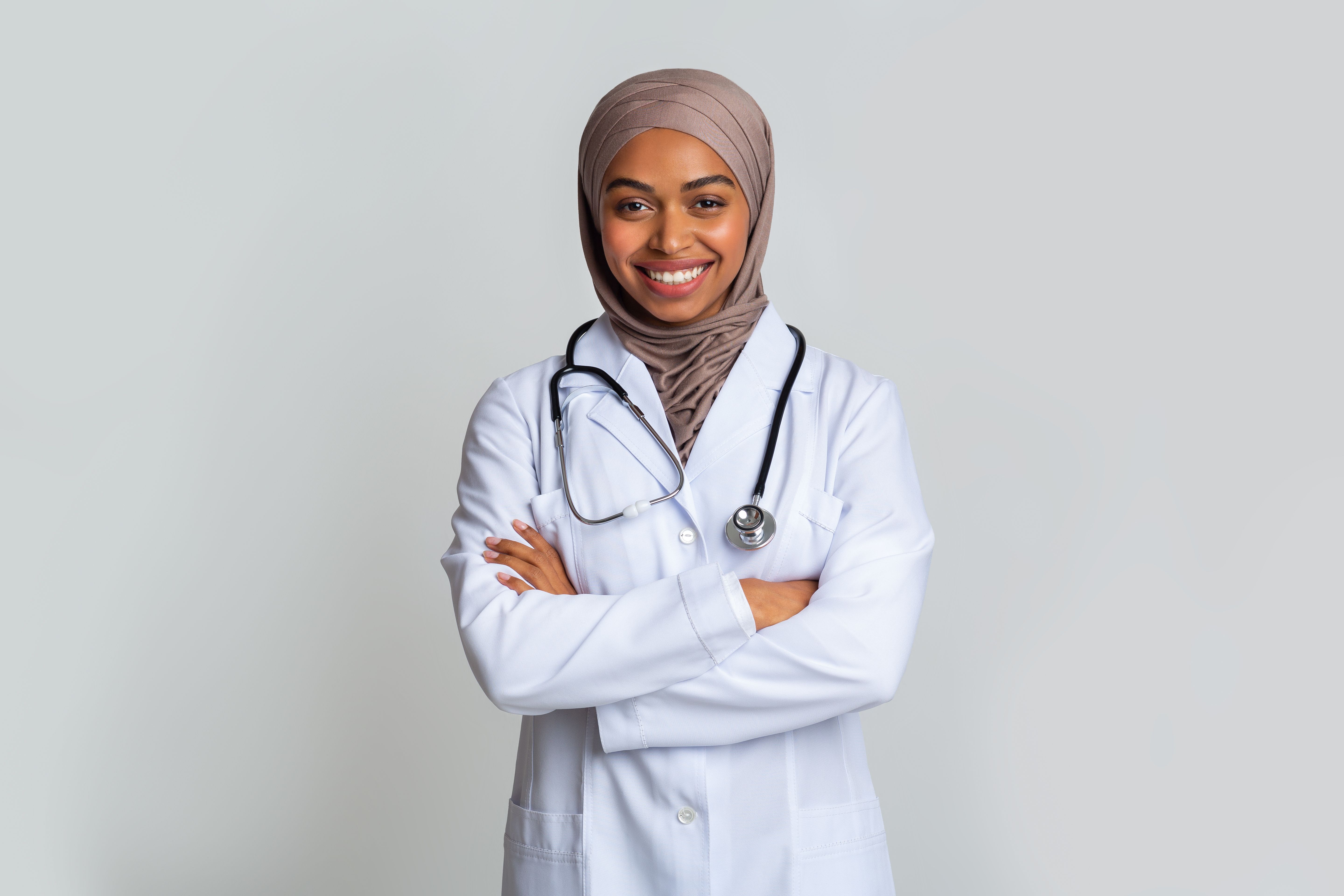 Portrait Of Black Female Doctor In Hijab Standing With Folded Arms