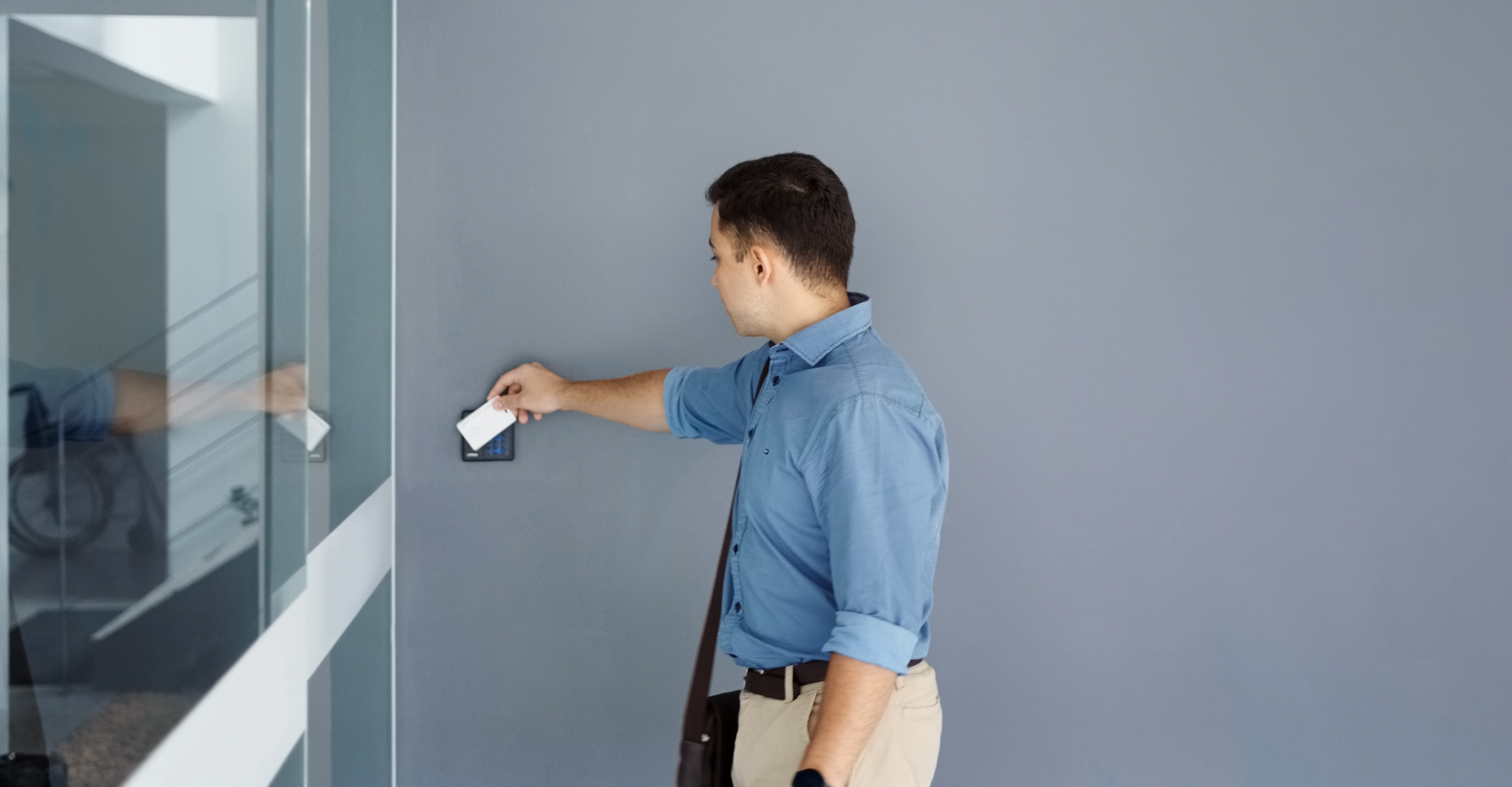 Young man using security key card  to open office door