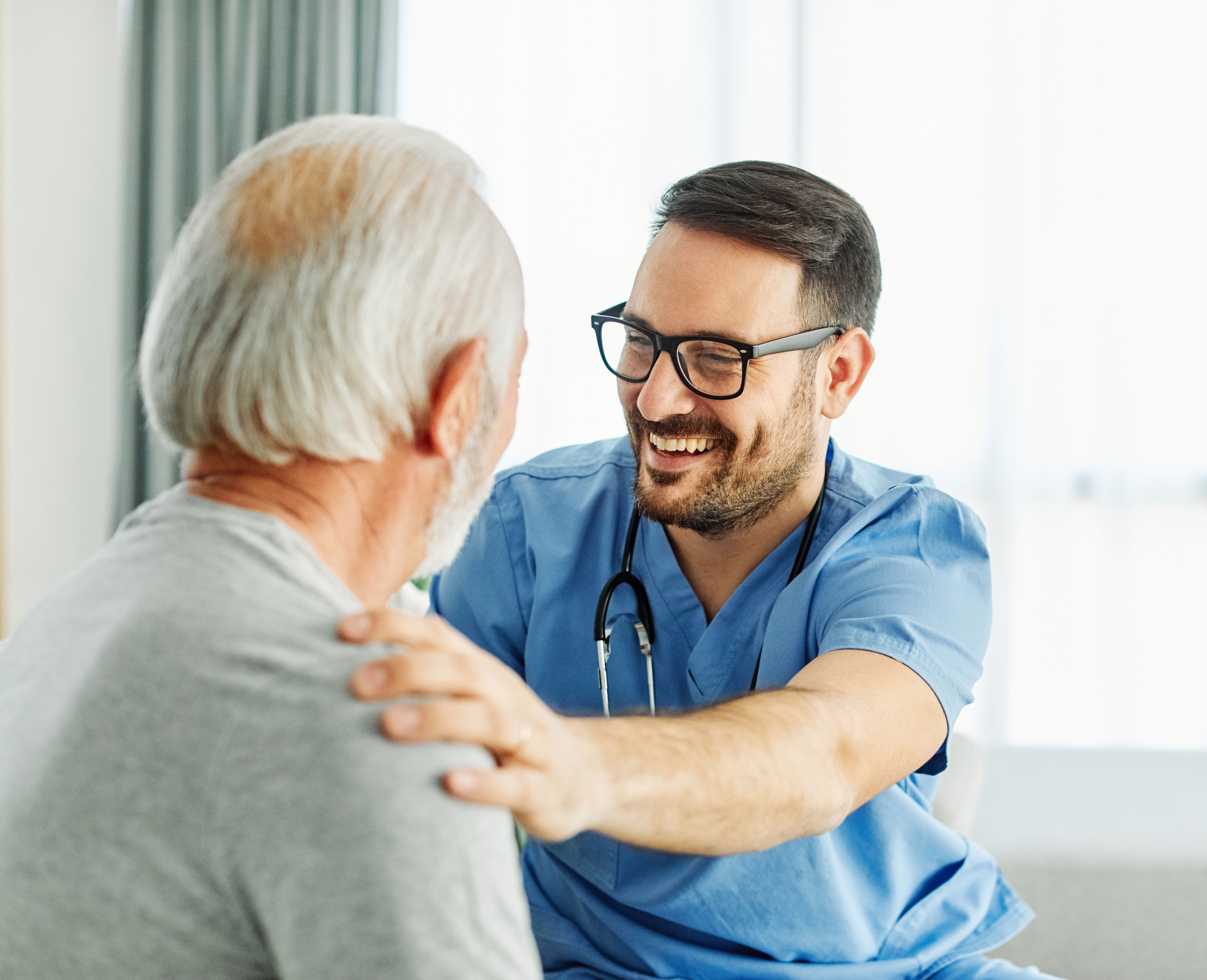 nurse doctor senior care caregiver help assistance retirement home nursing elderly man health portrait support hand shoulder care hug hugging trust friend
