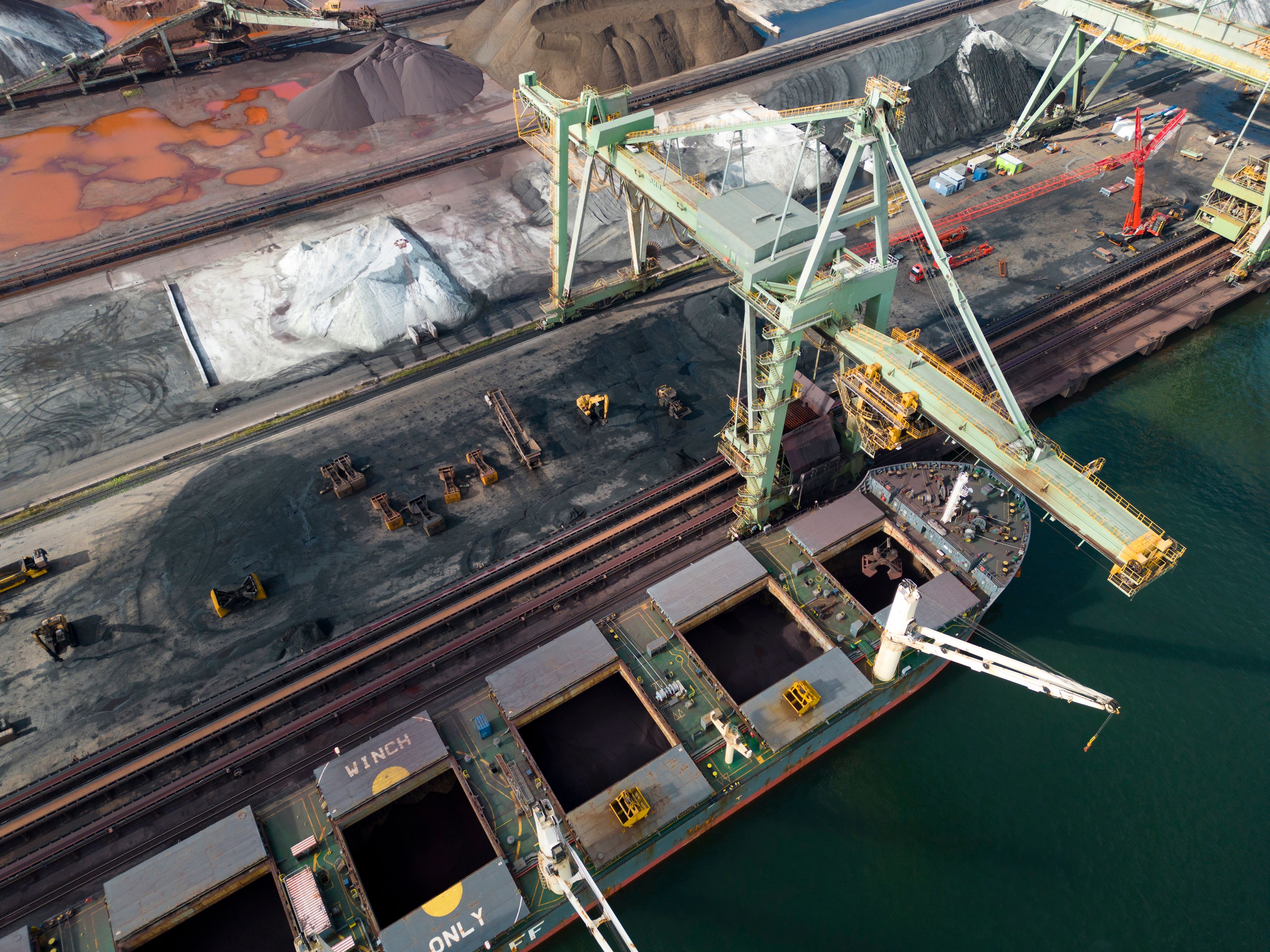 A large bulk carrier supplying iron-ore in a harbor