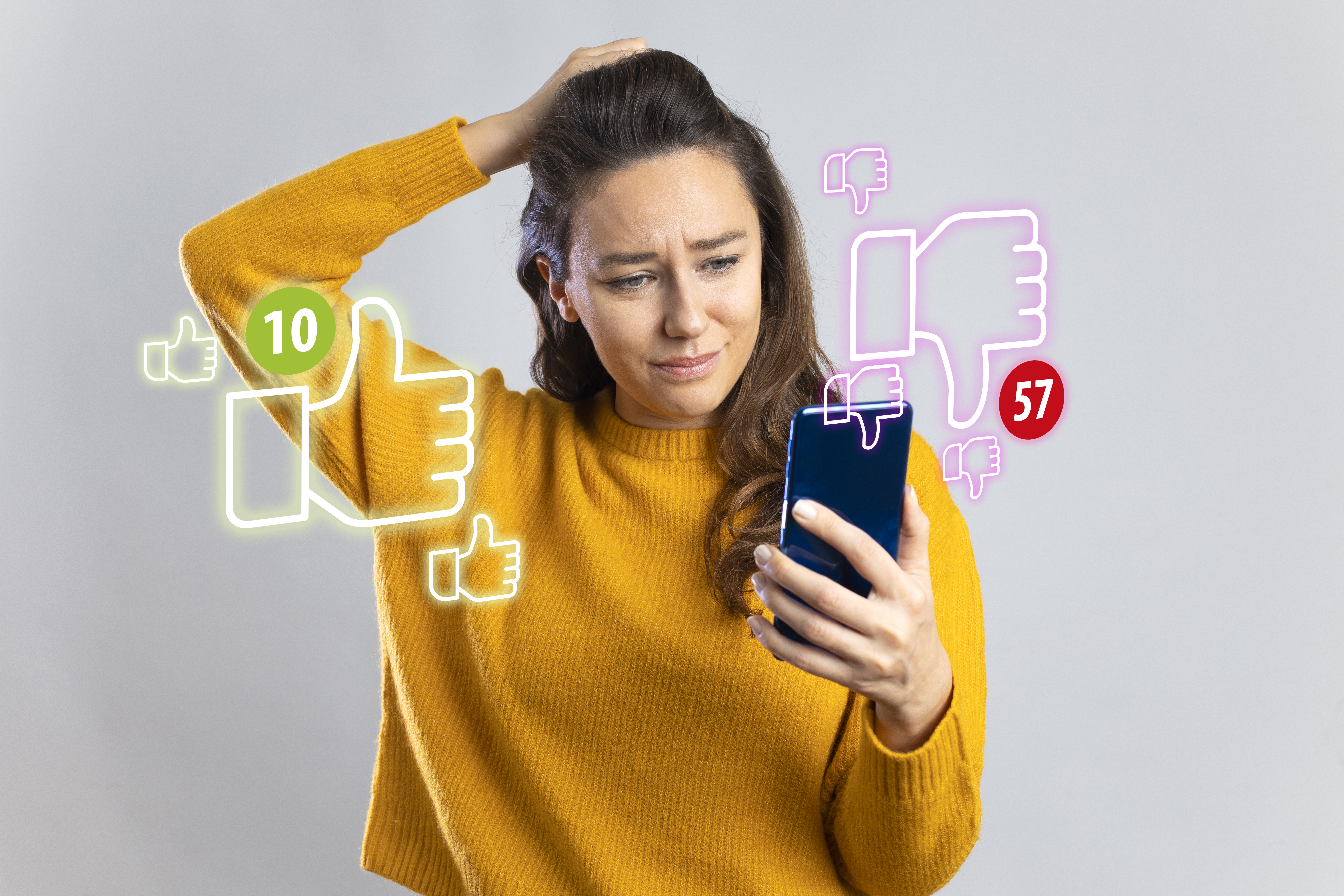 Young woman holding mobile phone looking too much dislikes on her social media post