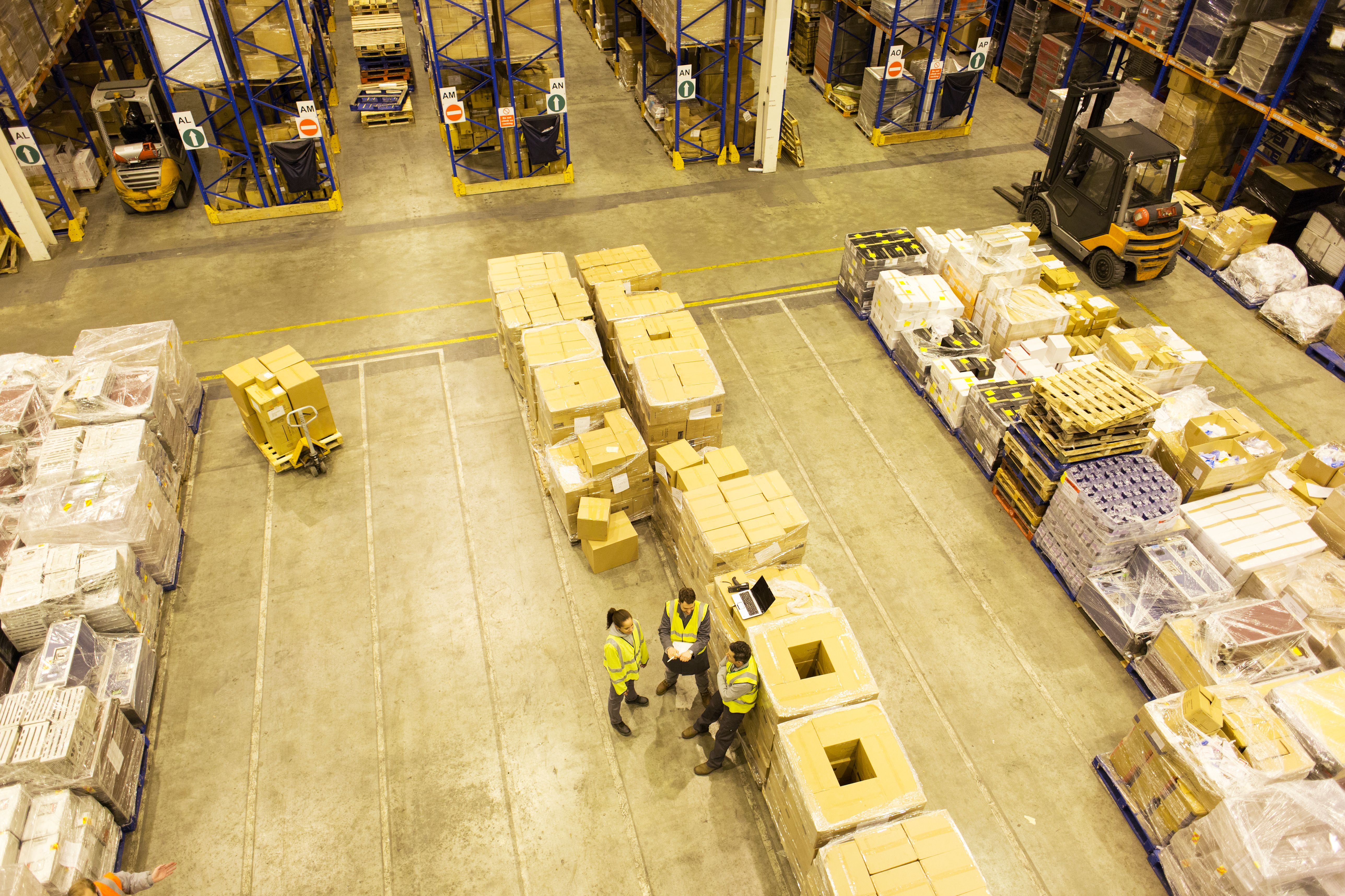 Workers talking in warehouse