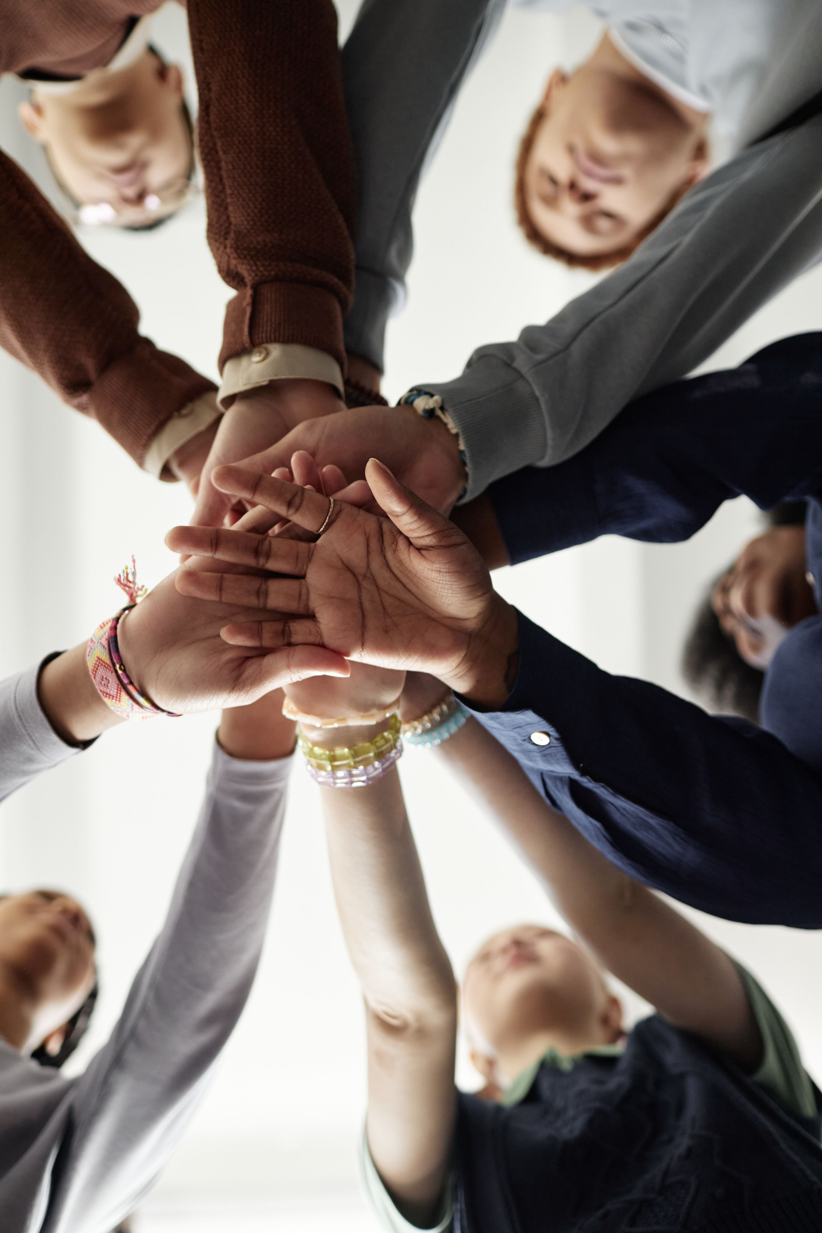 From Below Group of Children Stacking Hands