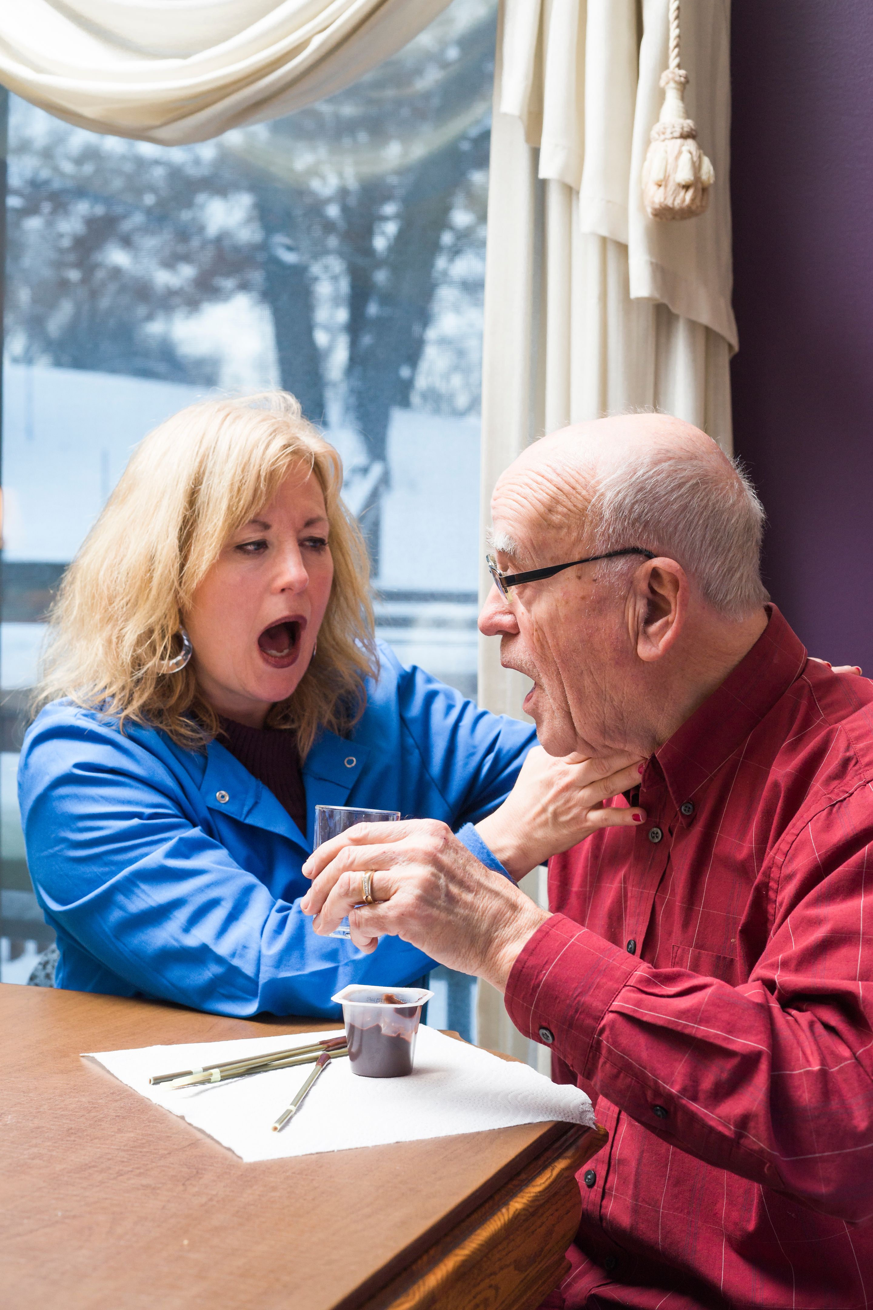Speech therapist listens for dry voicing after swallowing