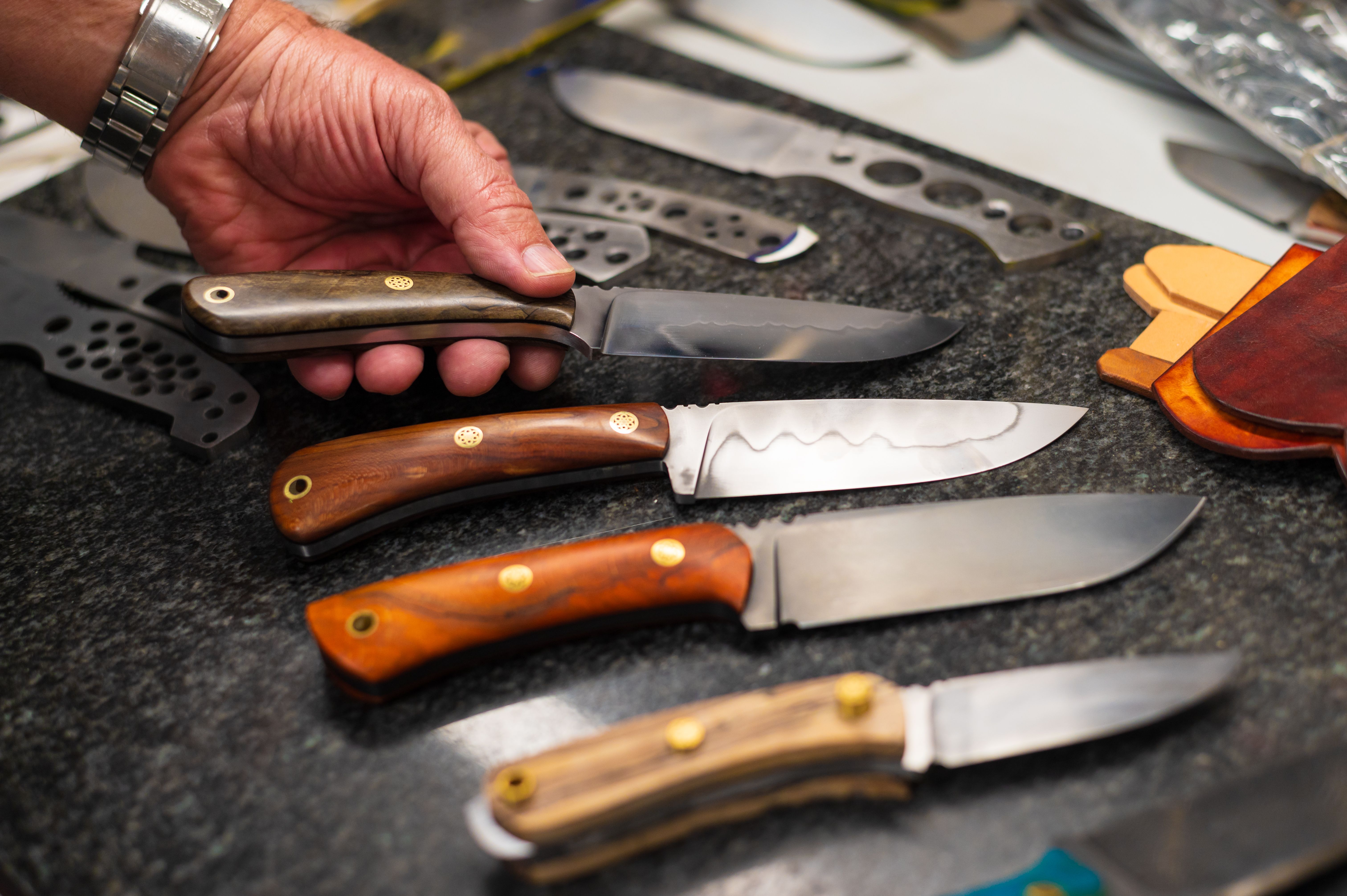 Senior craftsman knife maker making handmade stainless steel knives