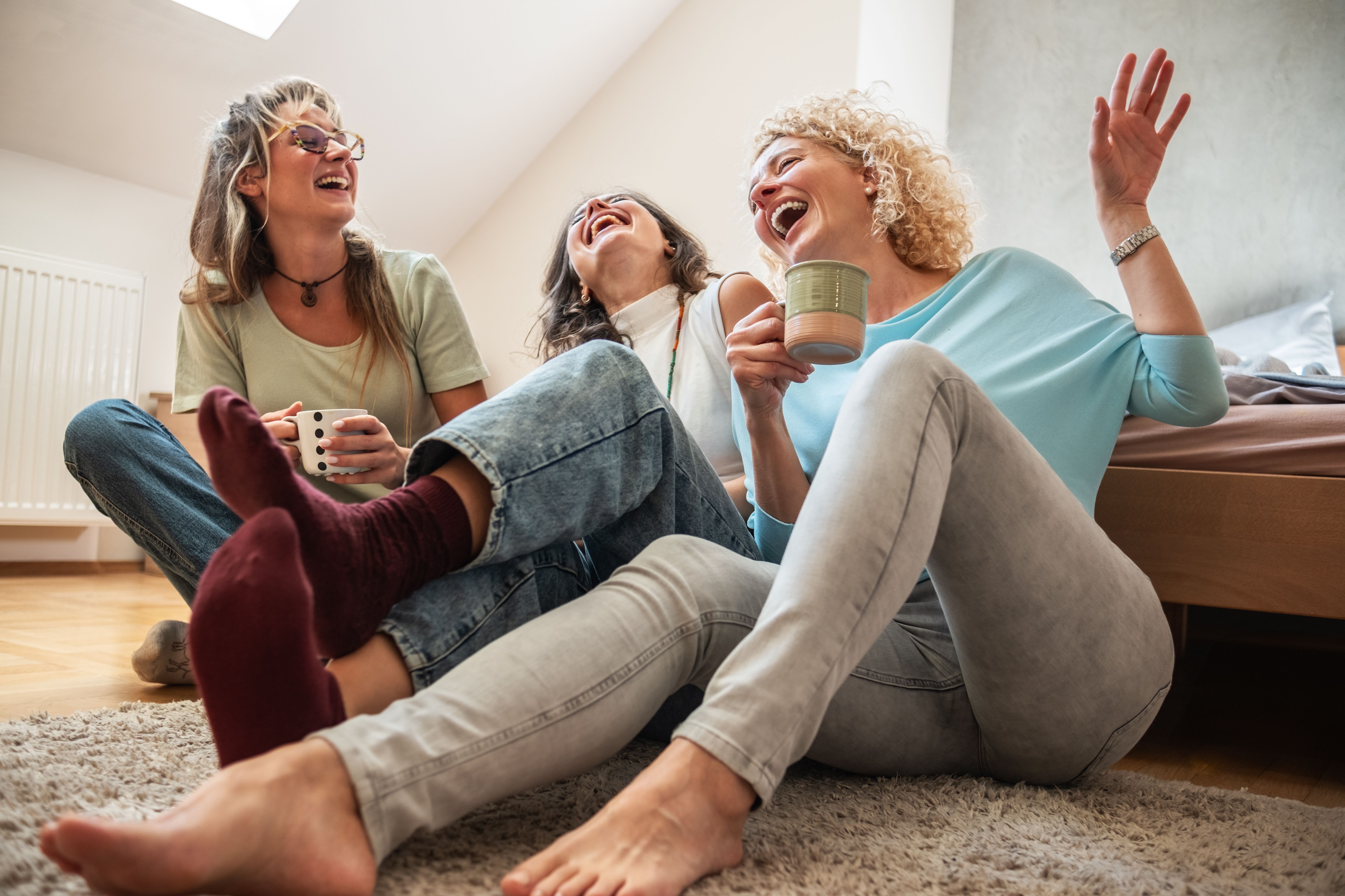 A modern mother enjoys a coffee while spending time with her two daughters. A modern mother enjoys a coffee while spending time with her two daughters.