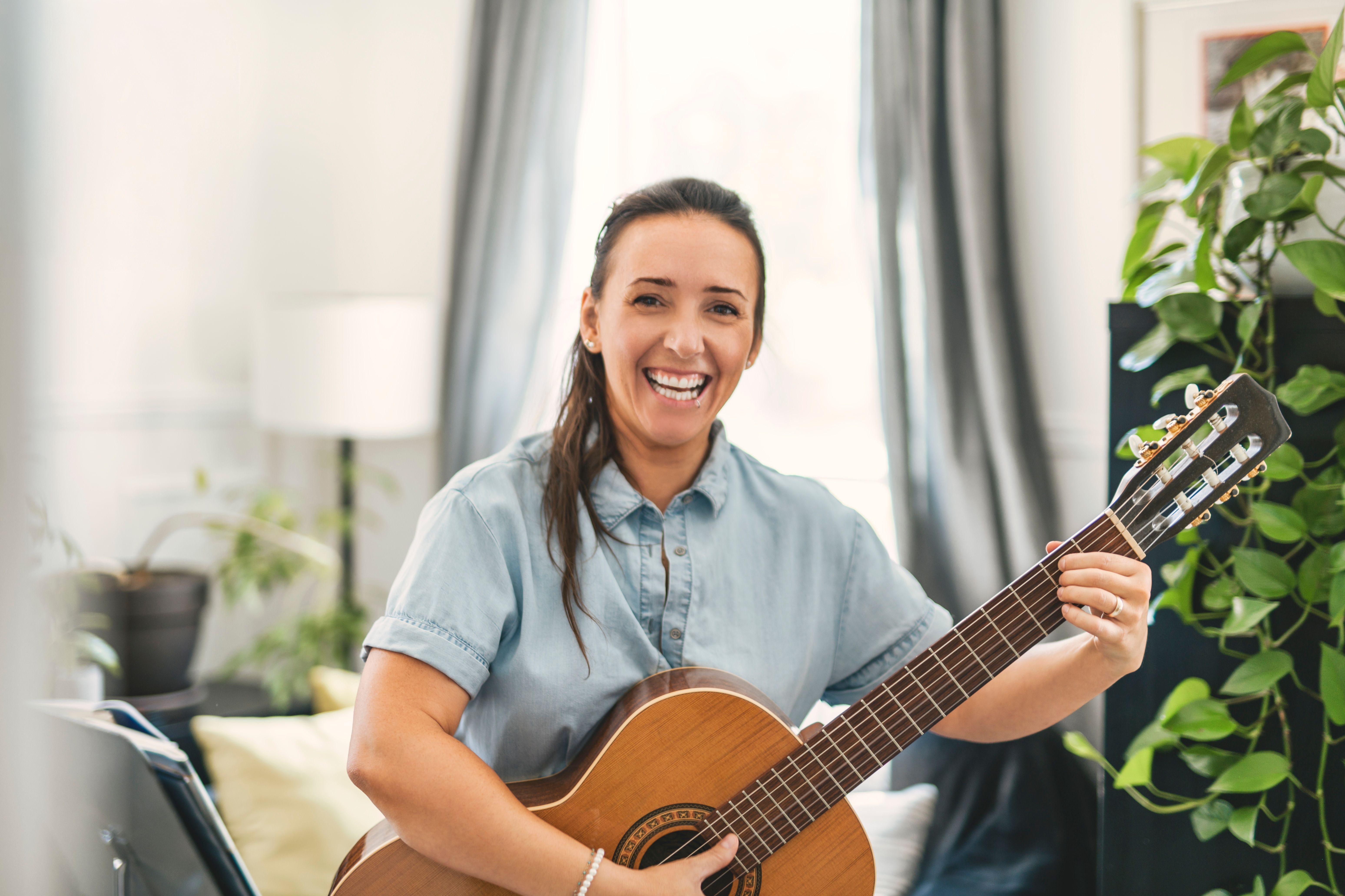 adult guitarist happy