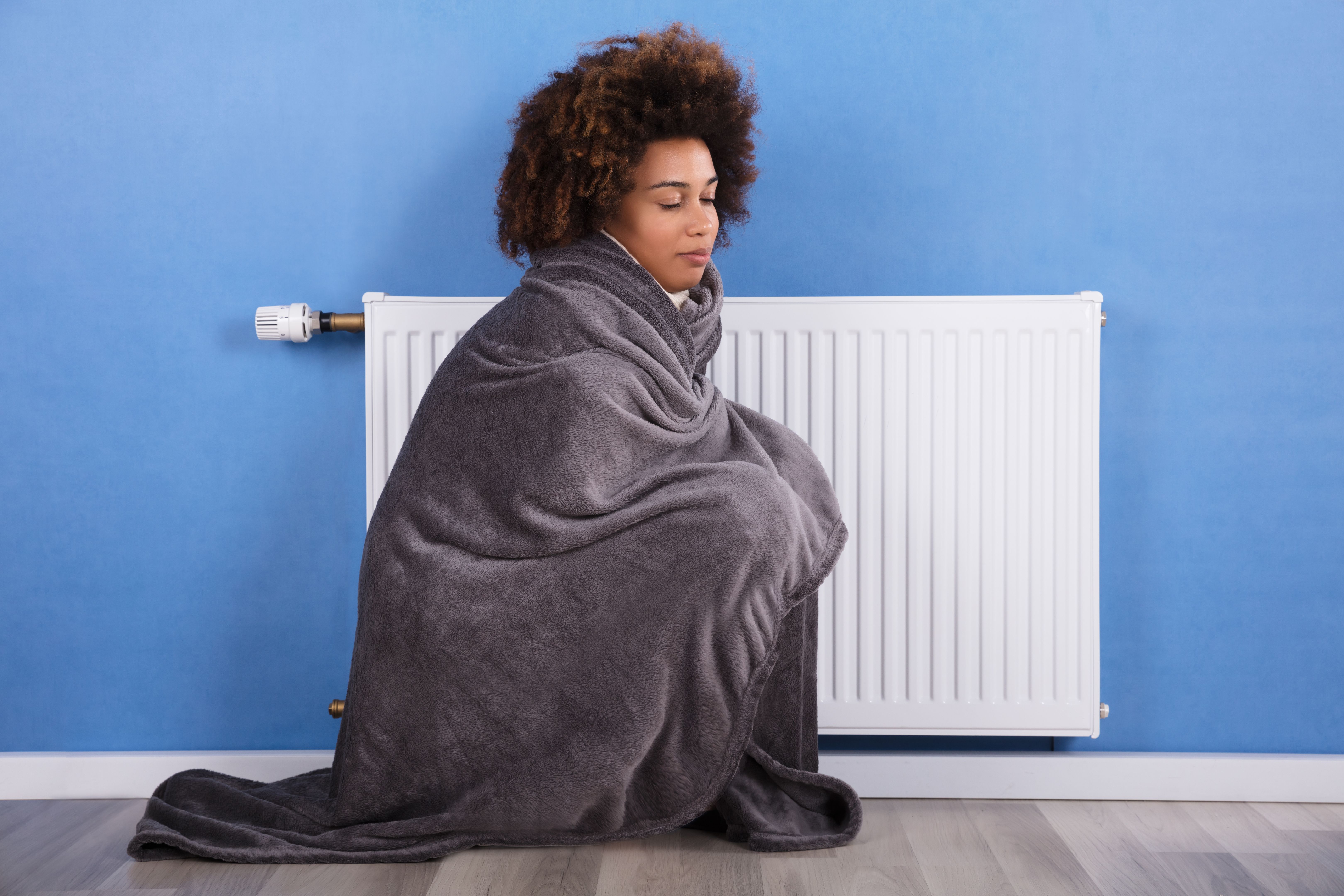 Woman Sitting Near Heater At Home Woman Sitting Near Heater At Home