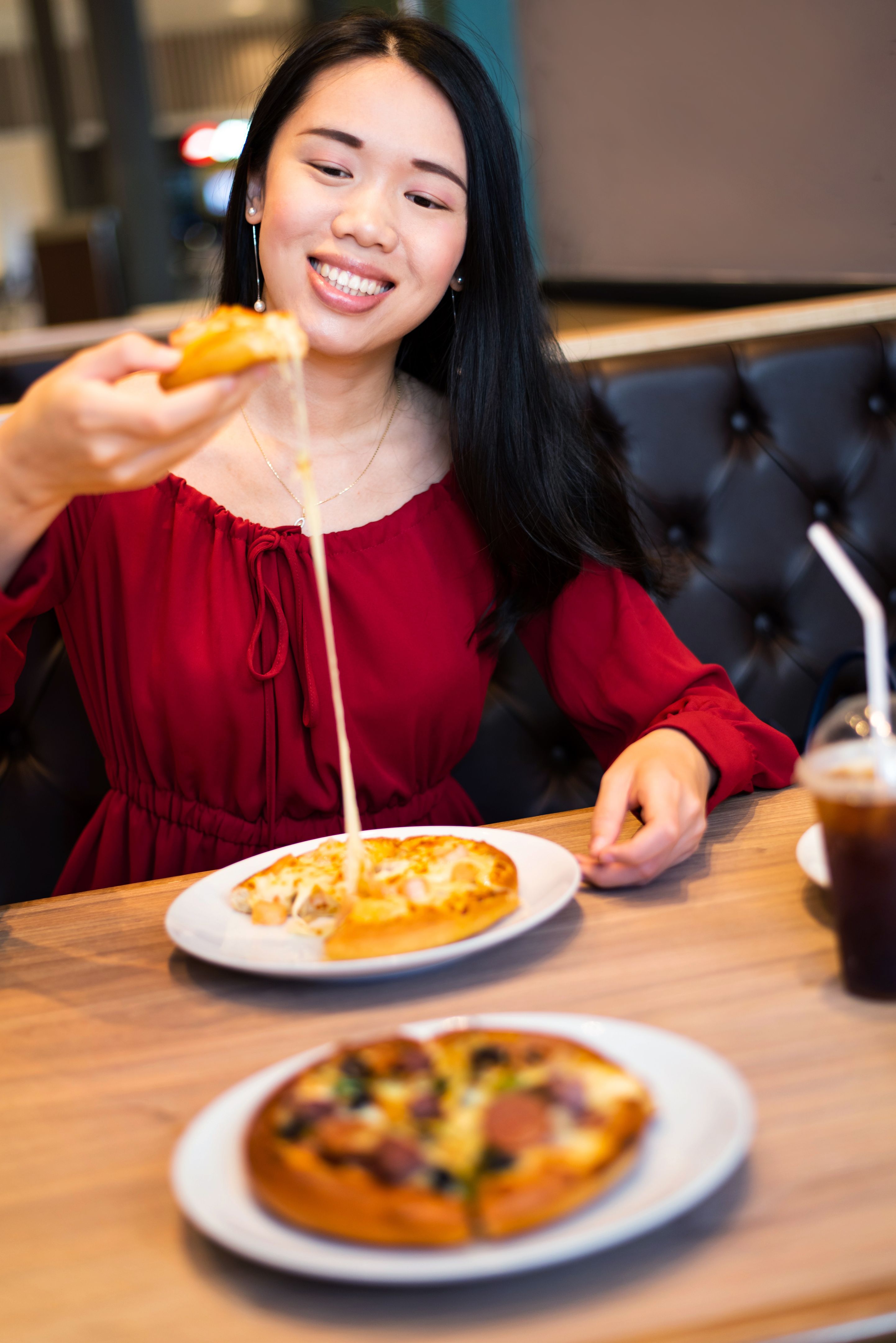 Girl eating pizza in the restaurant