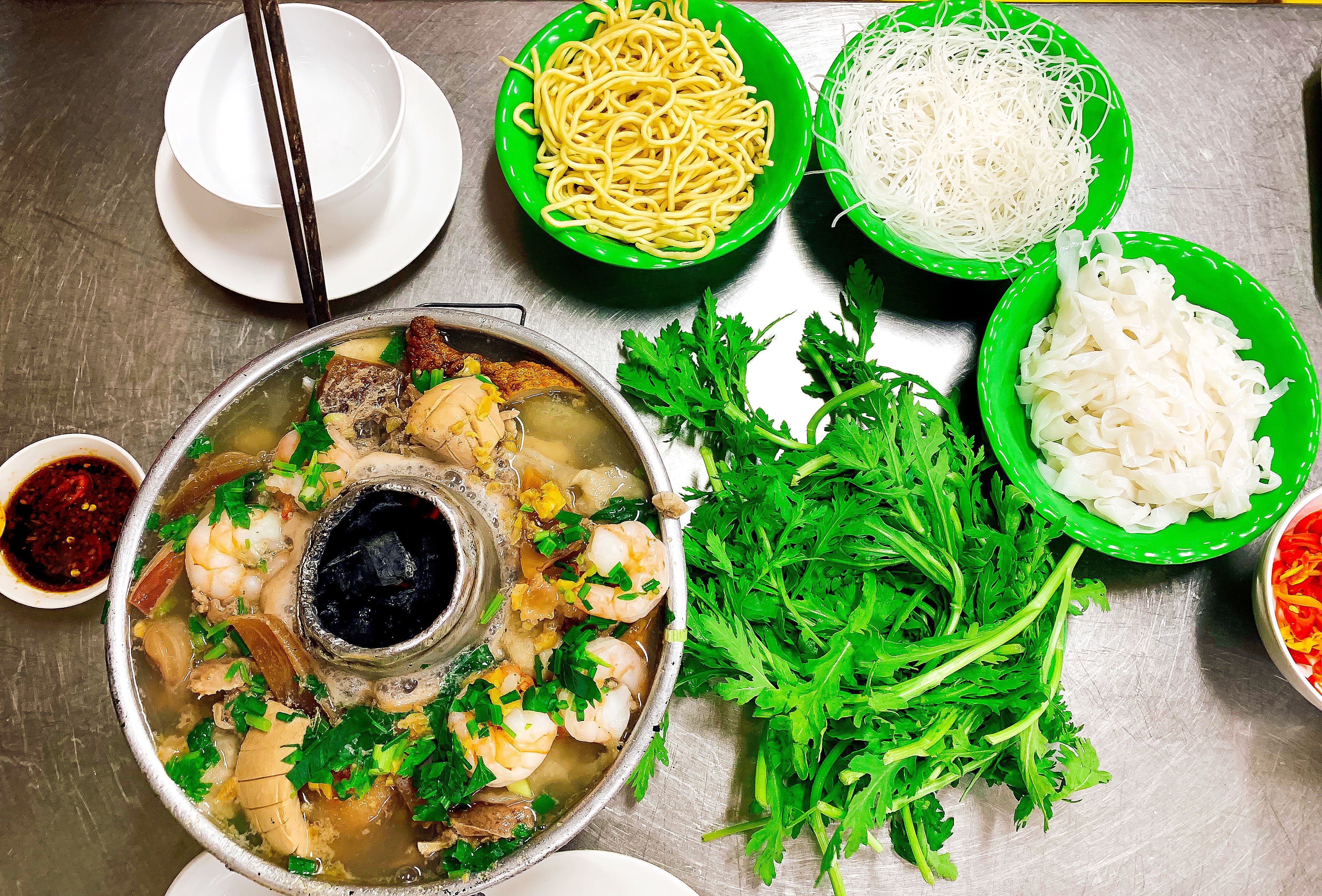 Vietnamese Fish Hot Pot With Reice Noodles, Egg Noodles And Fresh Vegetables.