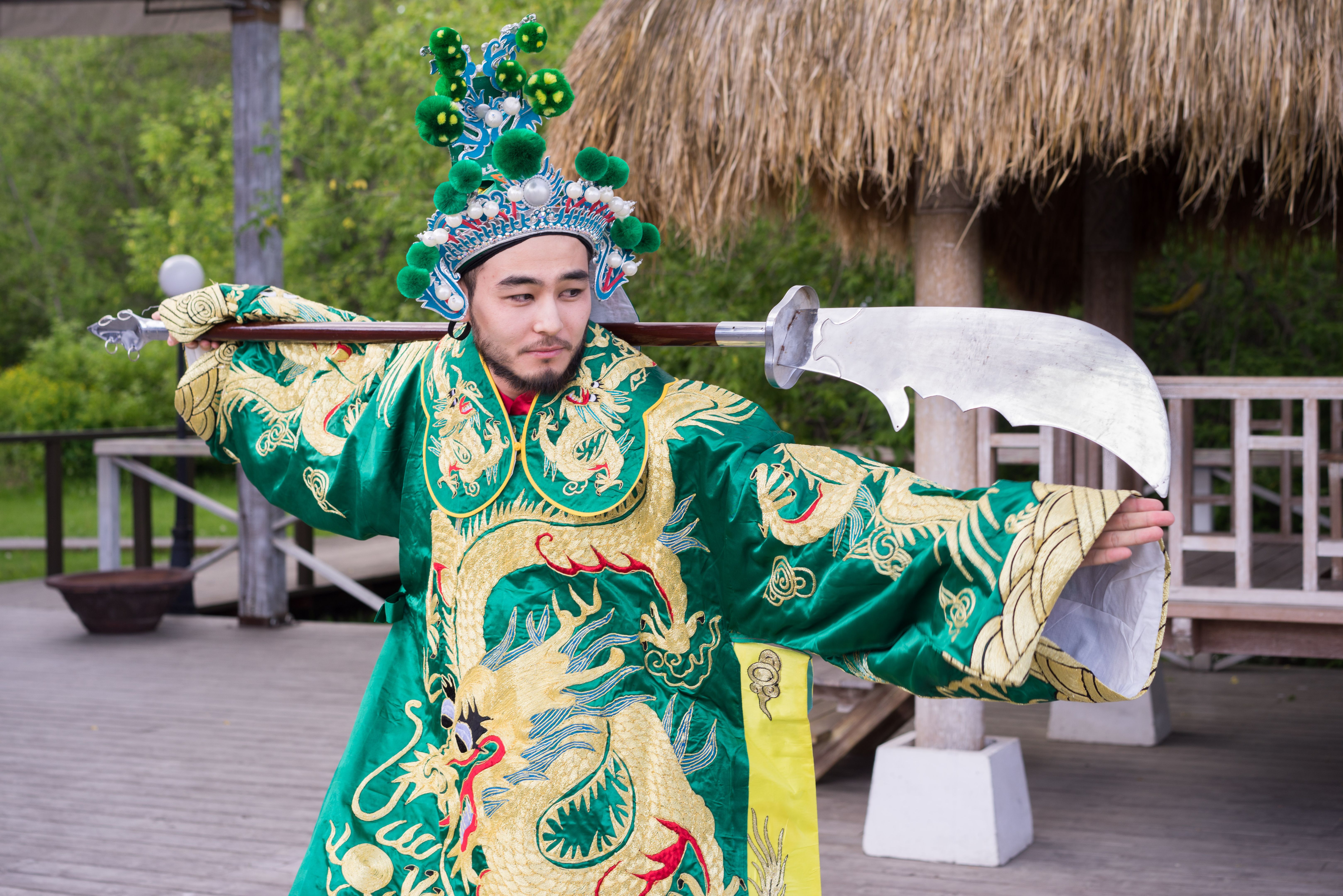 chinese man in traditional costume with sword outdoor