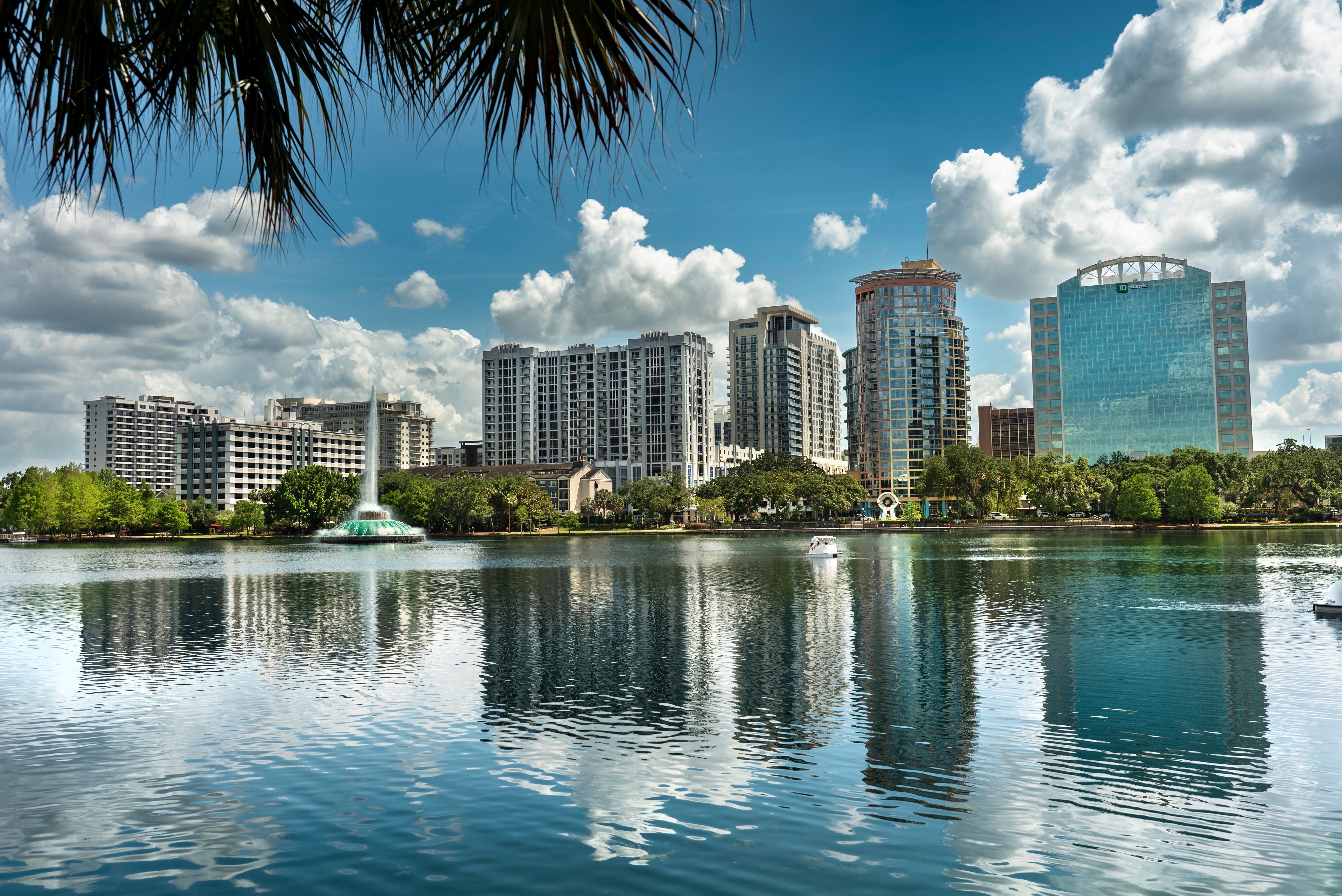 Orlando Florida city skyline over the waters of Lake Eola park in downtown