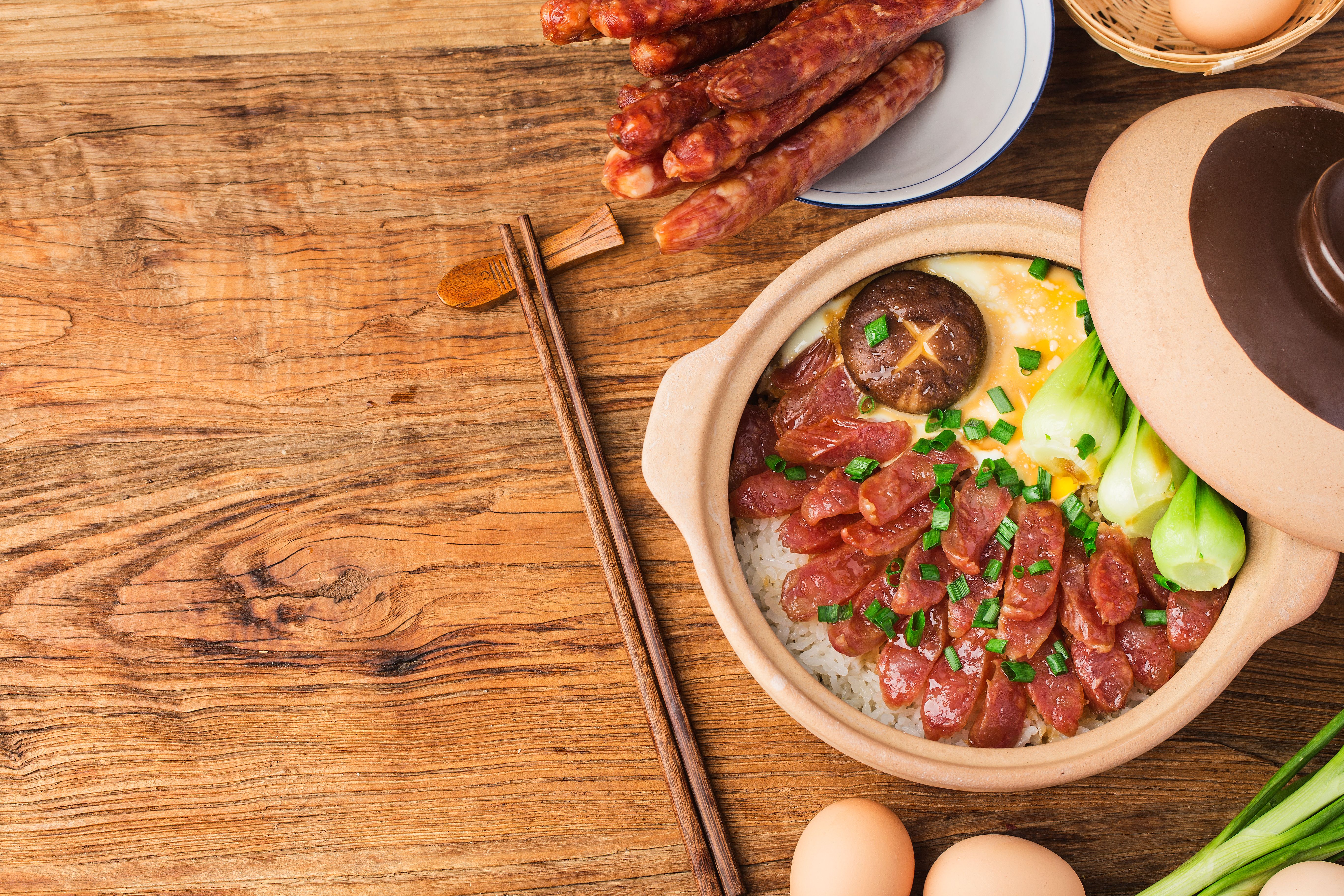 Cantonese style cooking of claypot rice with waxed meats