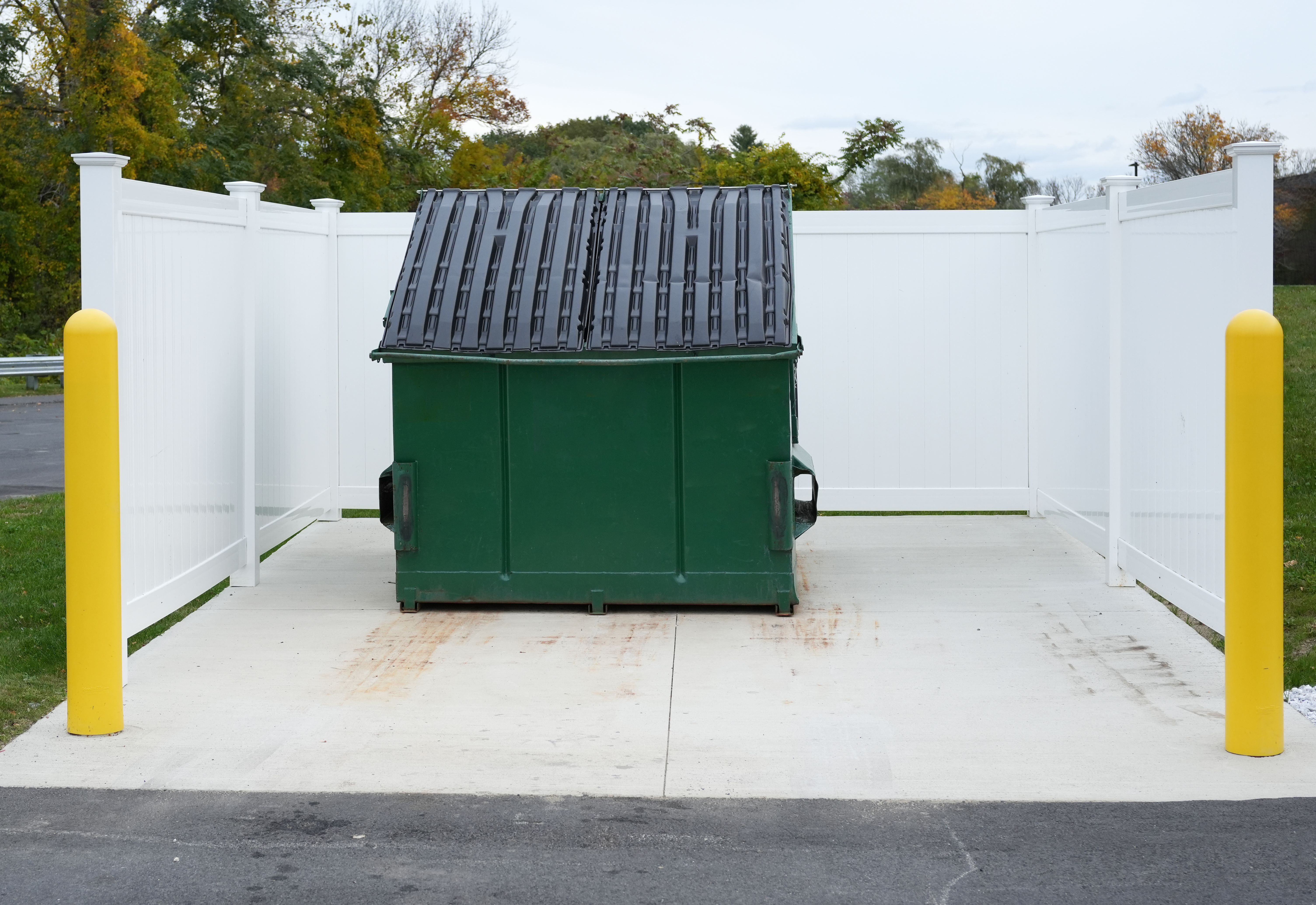 large green commercial dumpster for trash and recycling