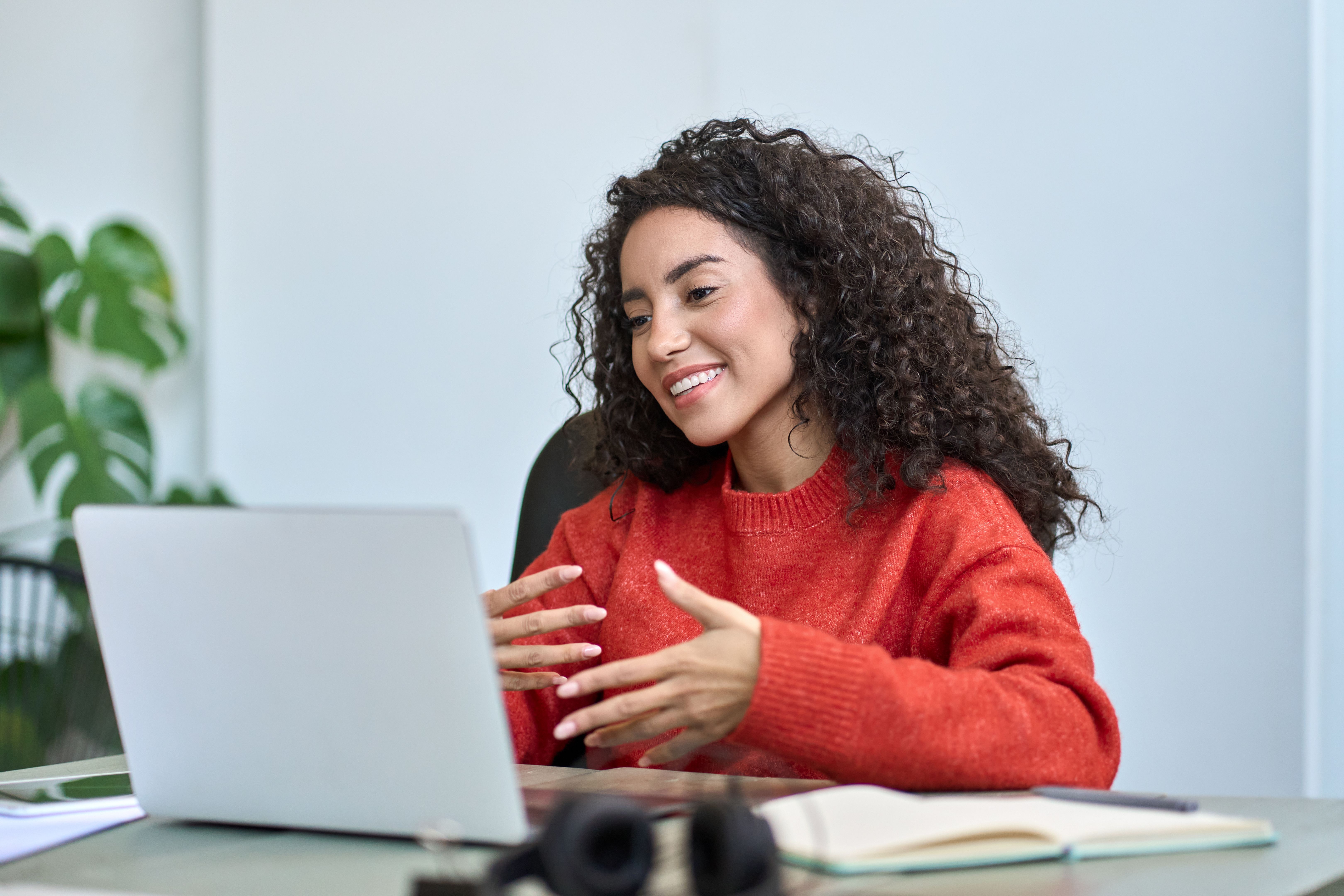 Happy latin business woman having video call hybrid meeting in office.
