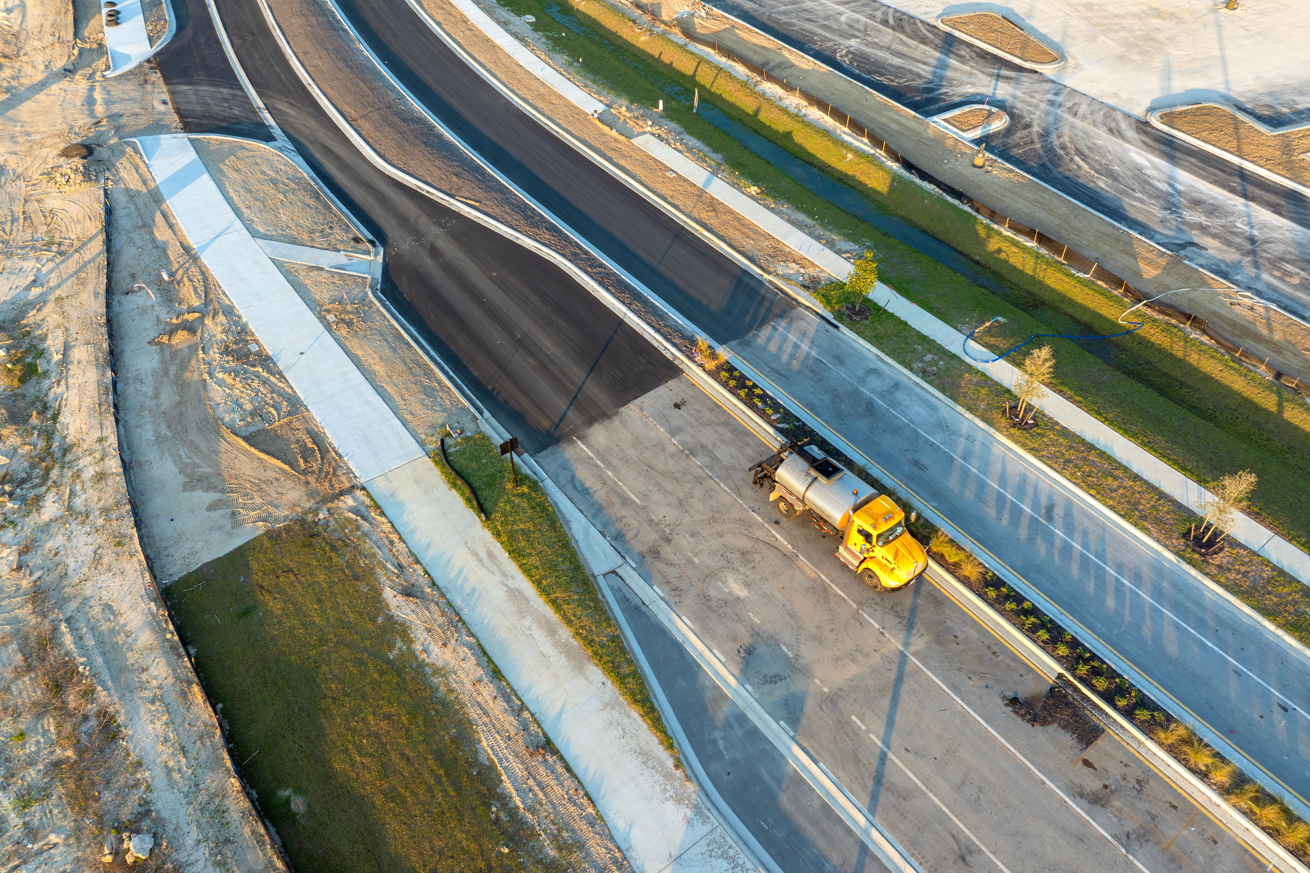 Highway construction in North Port, Florida. Development of American road with moving traffic cars. City transportation improvement Highway construction in North Port, Florida. Development of American road with moving traffic cars. City transportation improvement