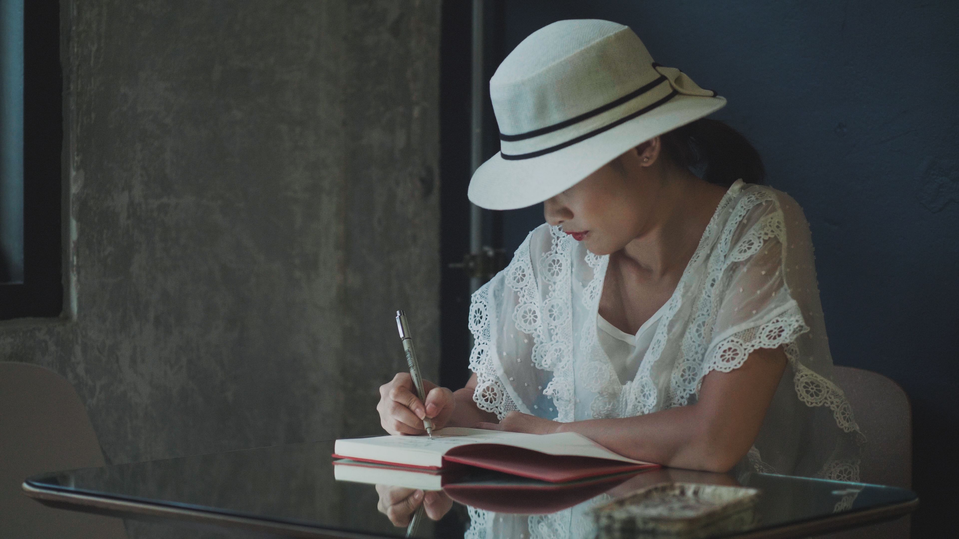 designer sketching hats