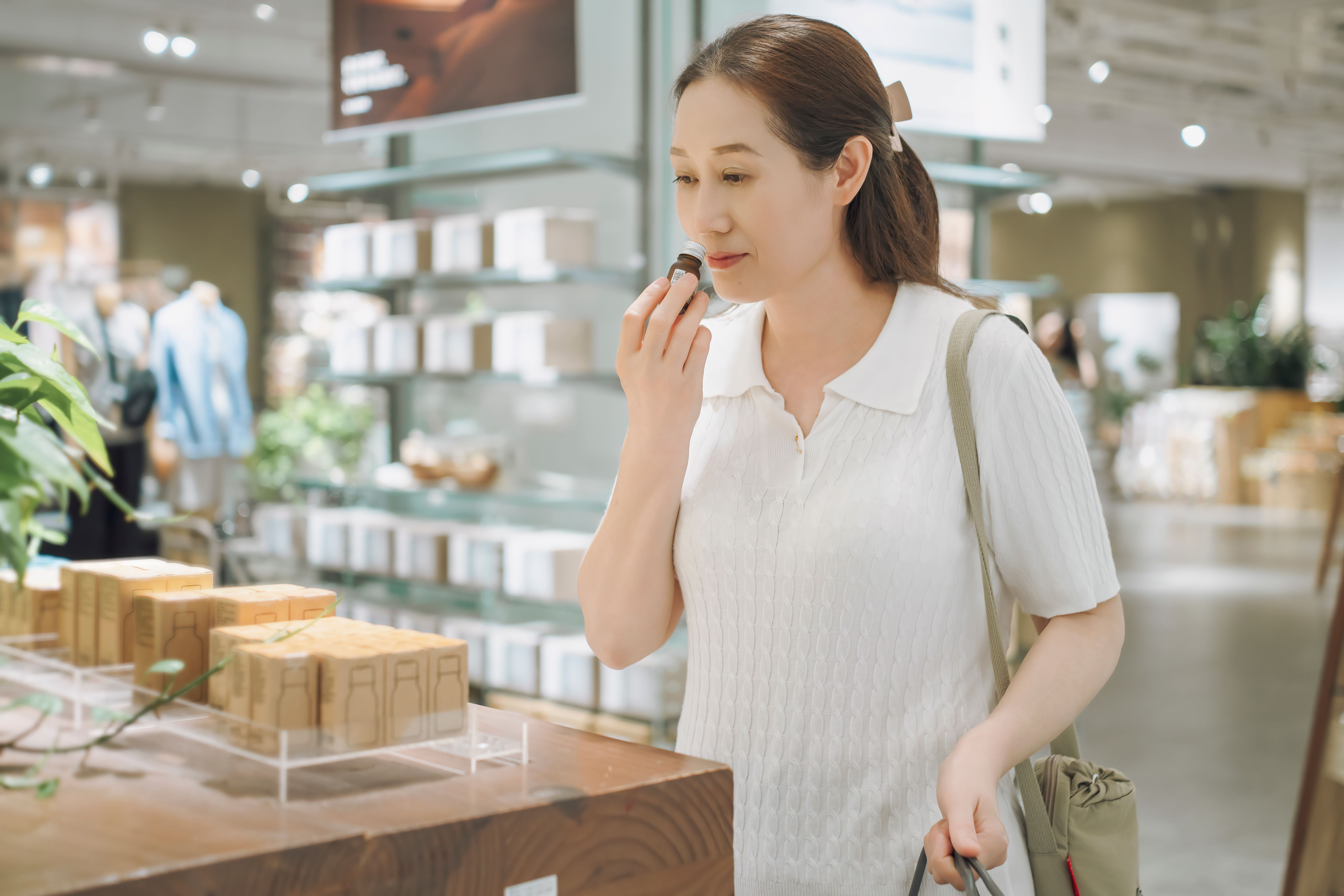 women smelling perfume