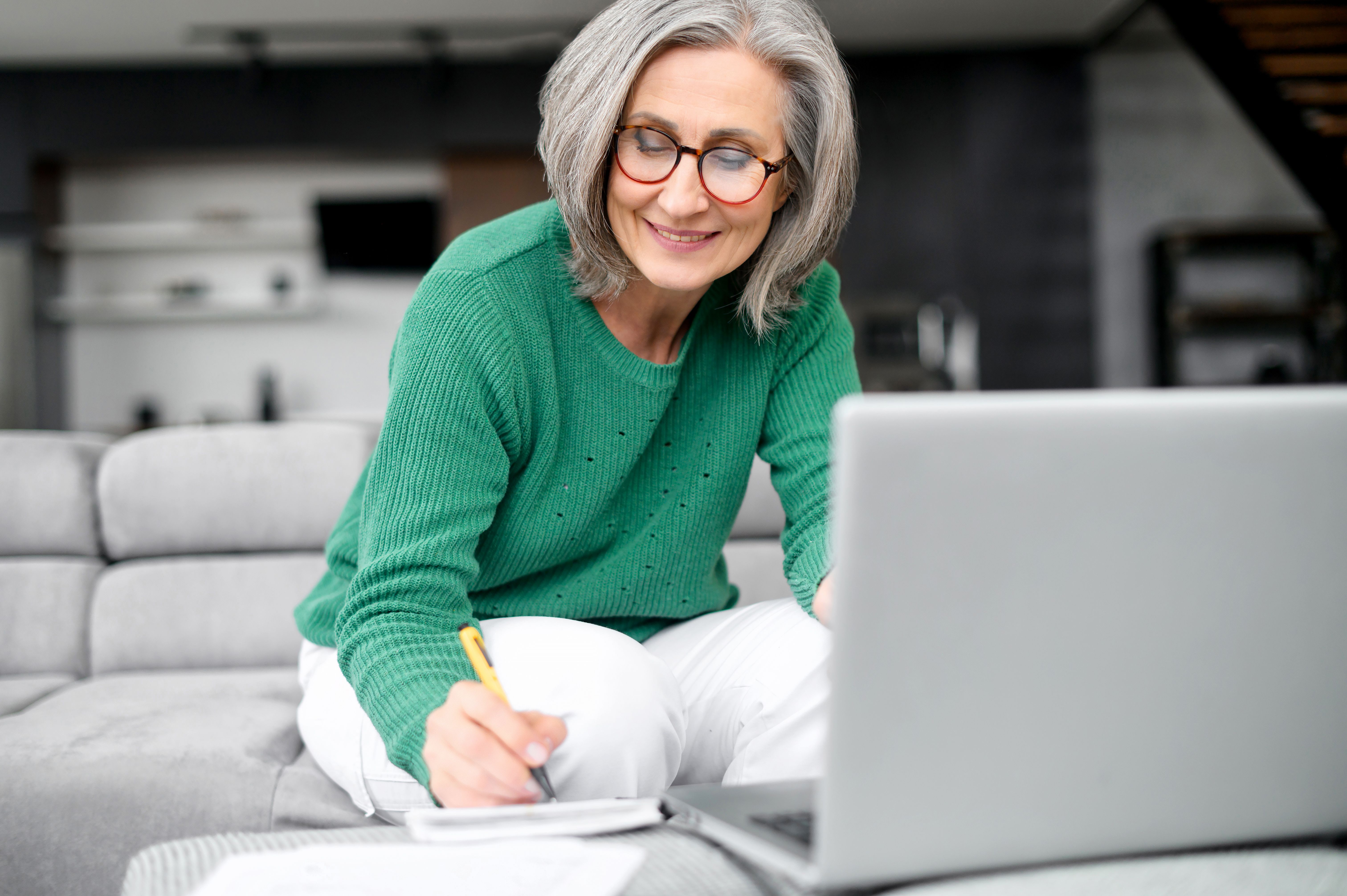 Beautiful senior woman using laptop at home