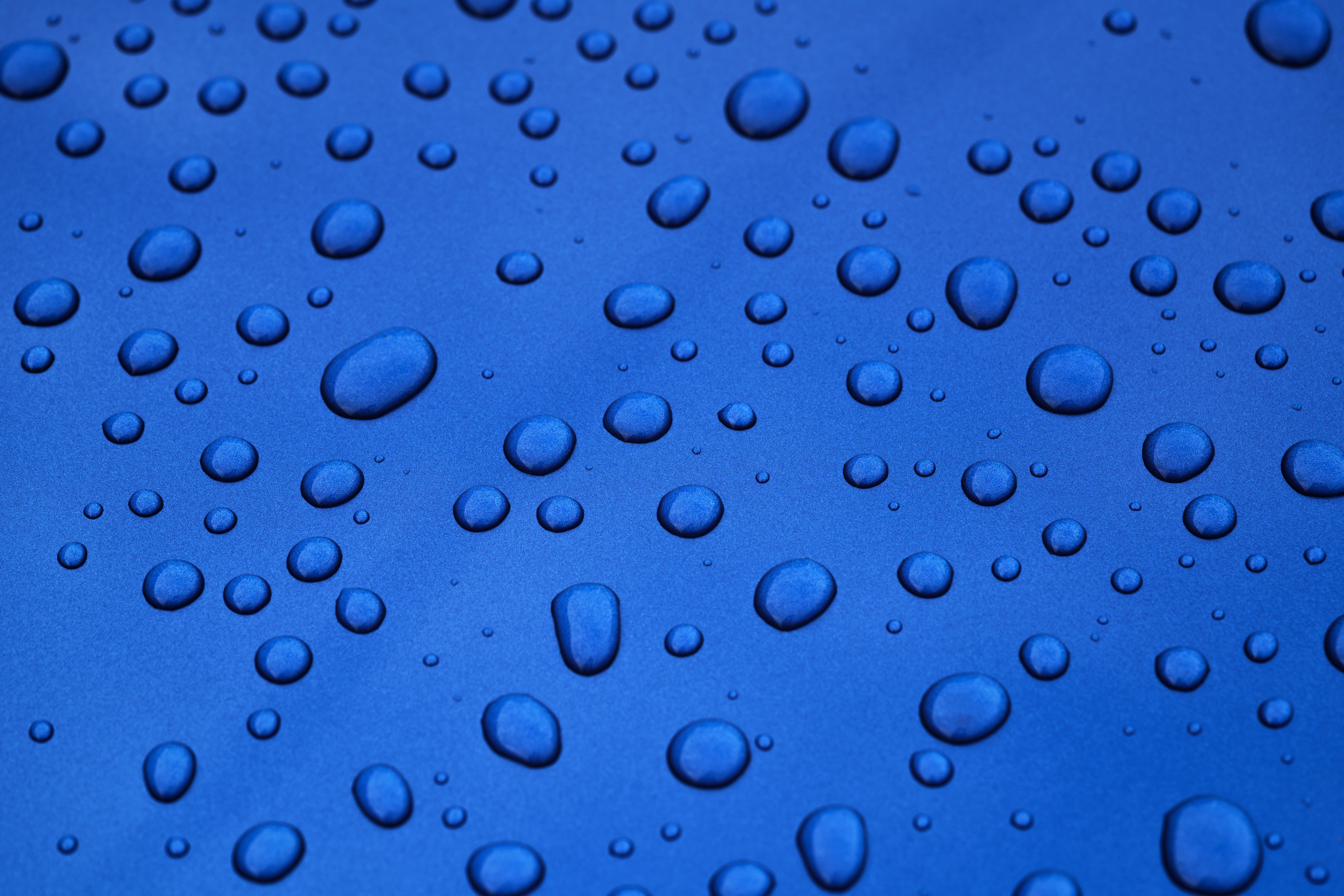 water drops on blue car body threated with protective coating