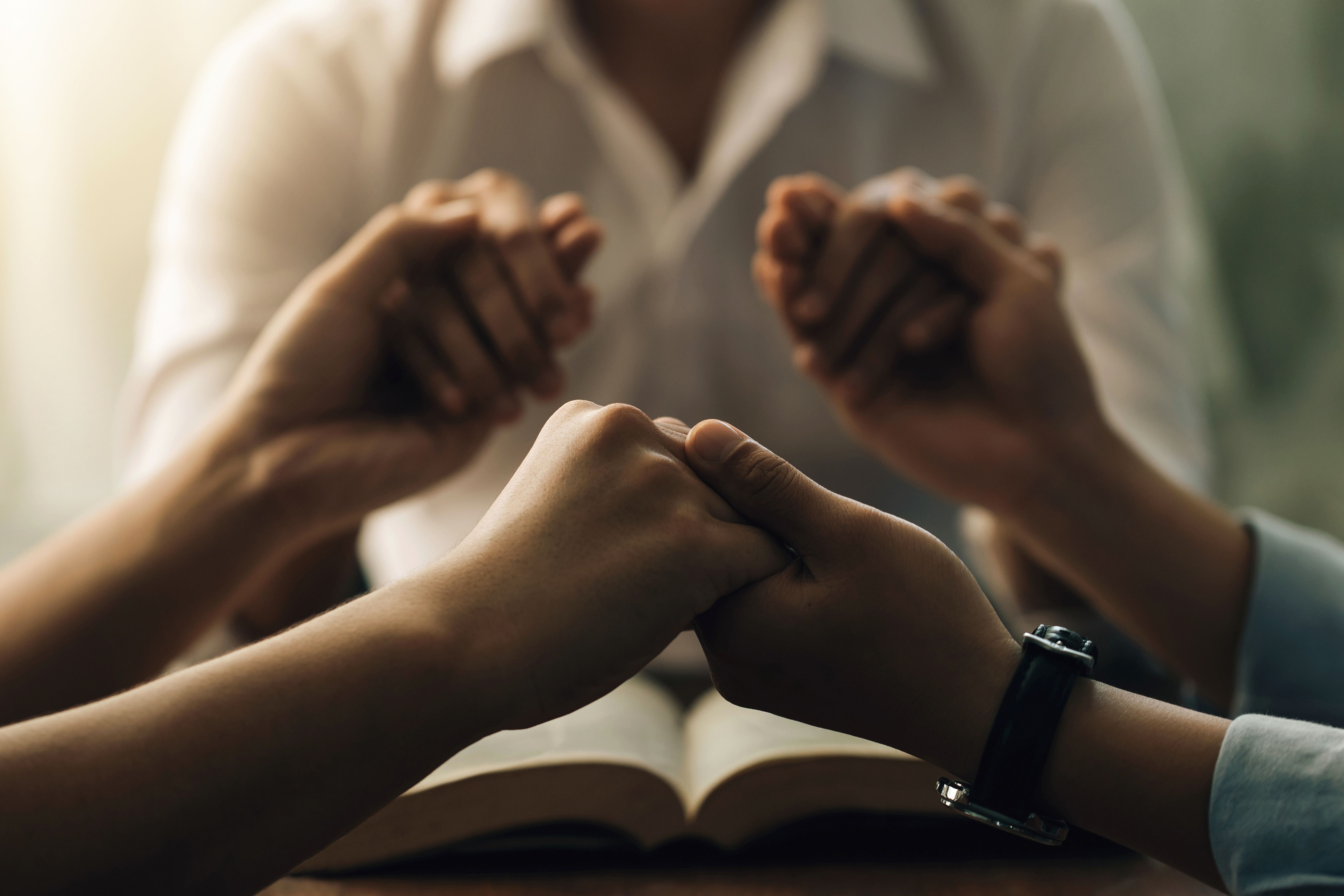 A FAMILY THAT PRAYS TOGETHER STAYS TOGETHER... e Holy Bible. They were reading the Bible and sharing the gospel. Christians and Bible study concept.