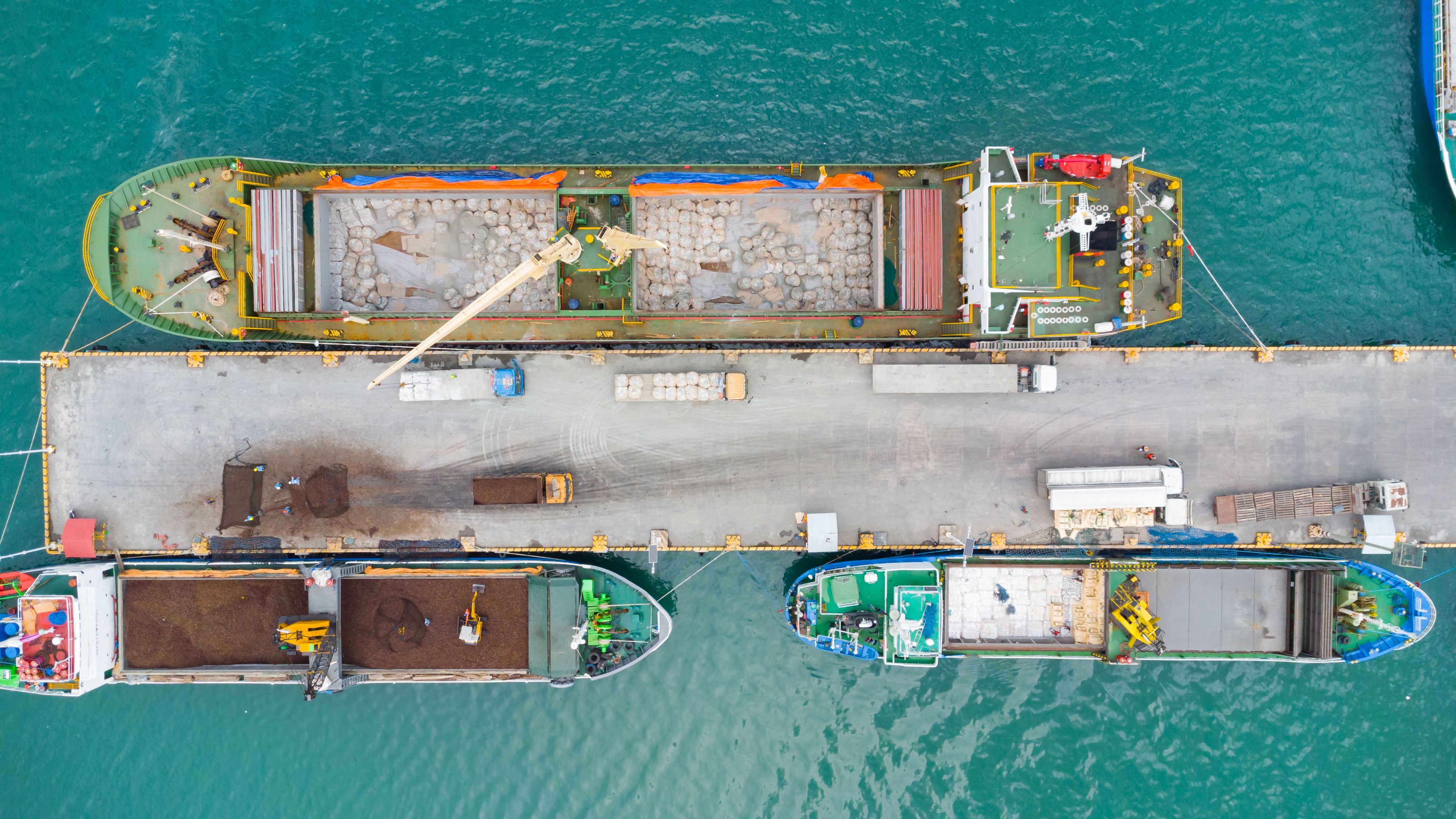 Loading a ship with containers at the port. Sea cargo transportation. Cargo. Aerial view