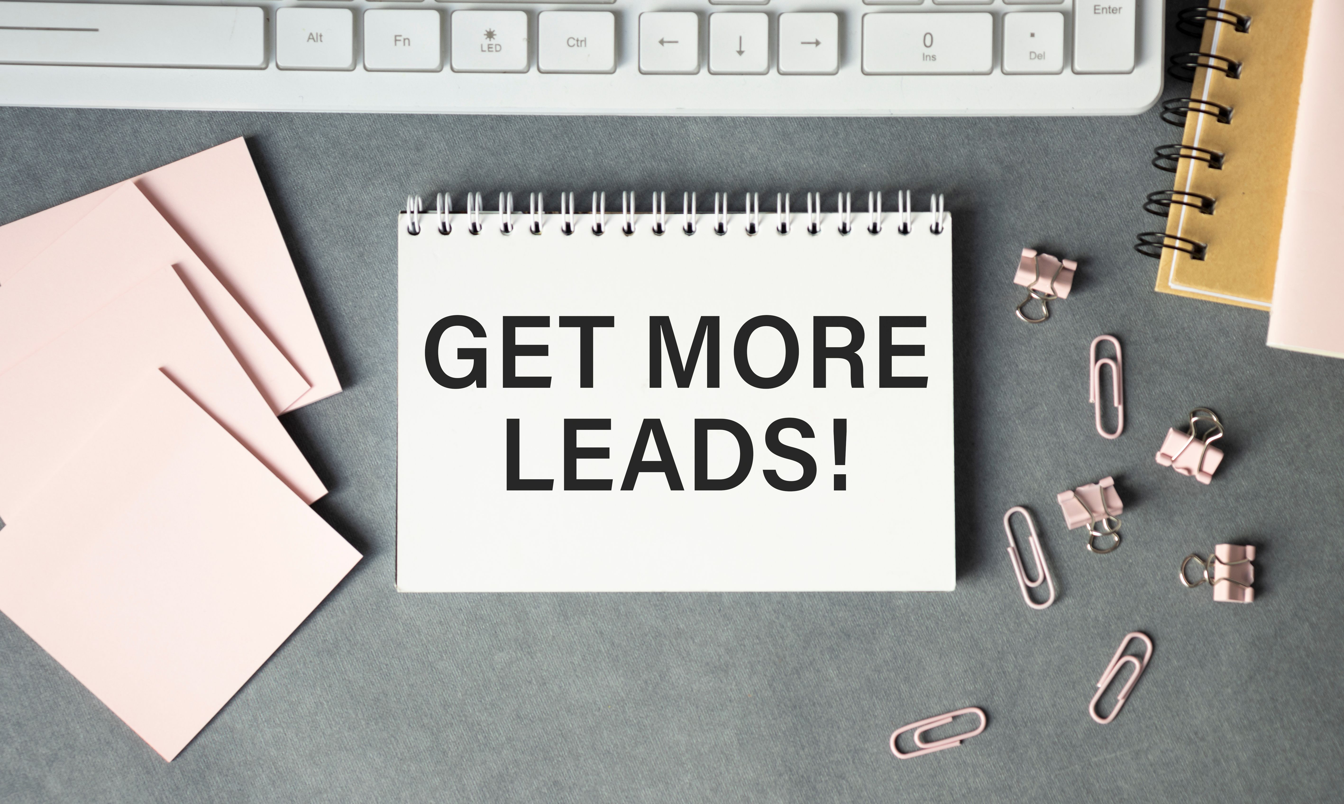 Get More Leads text as memo on notebook with tablet and phone