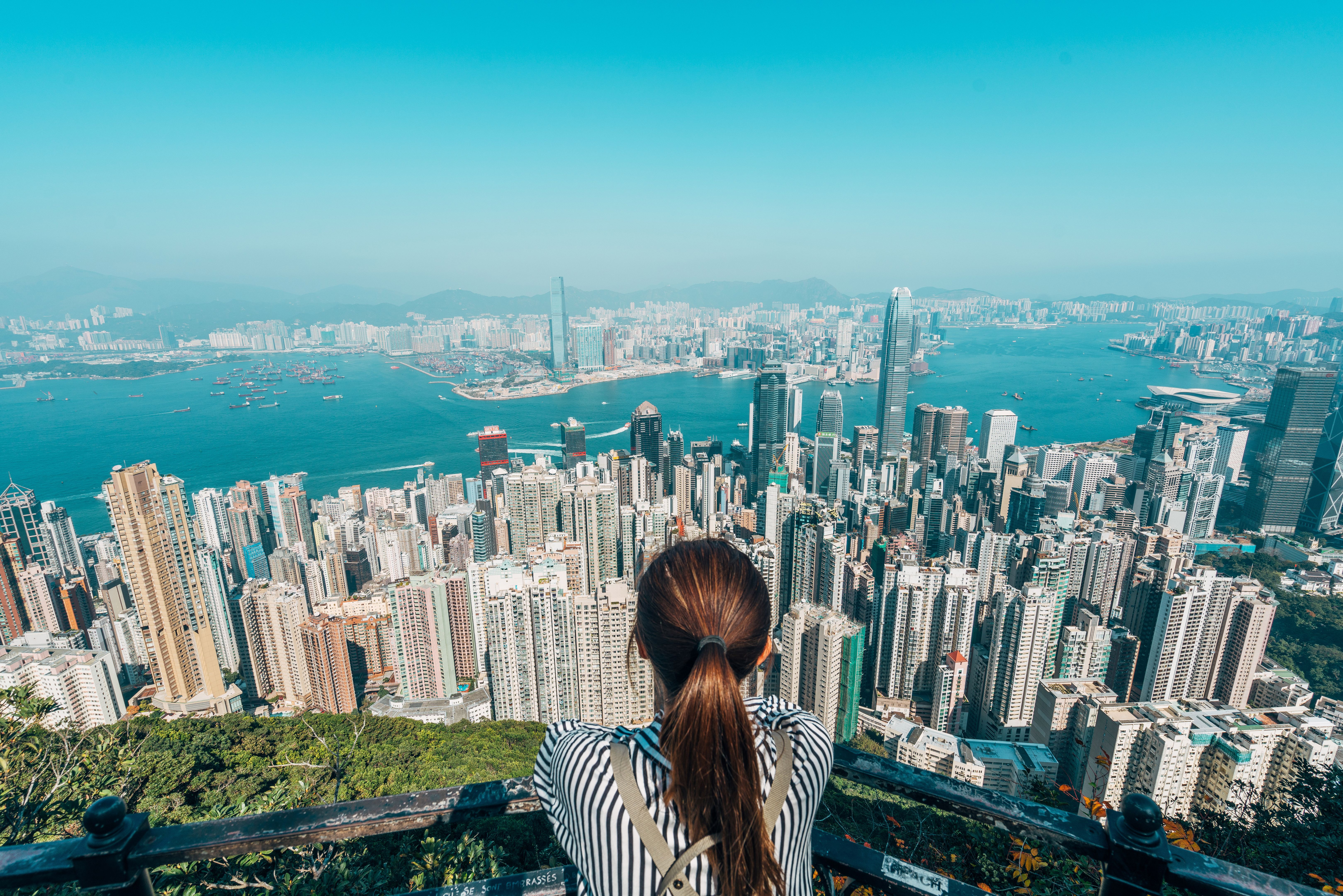 Rear View Of Woman Over Cityscape Against Sky