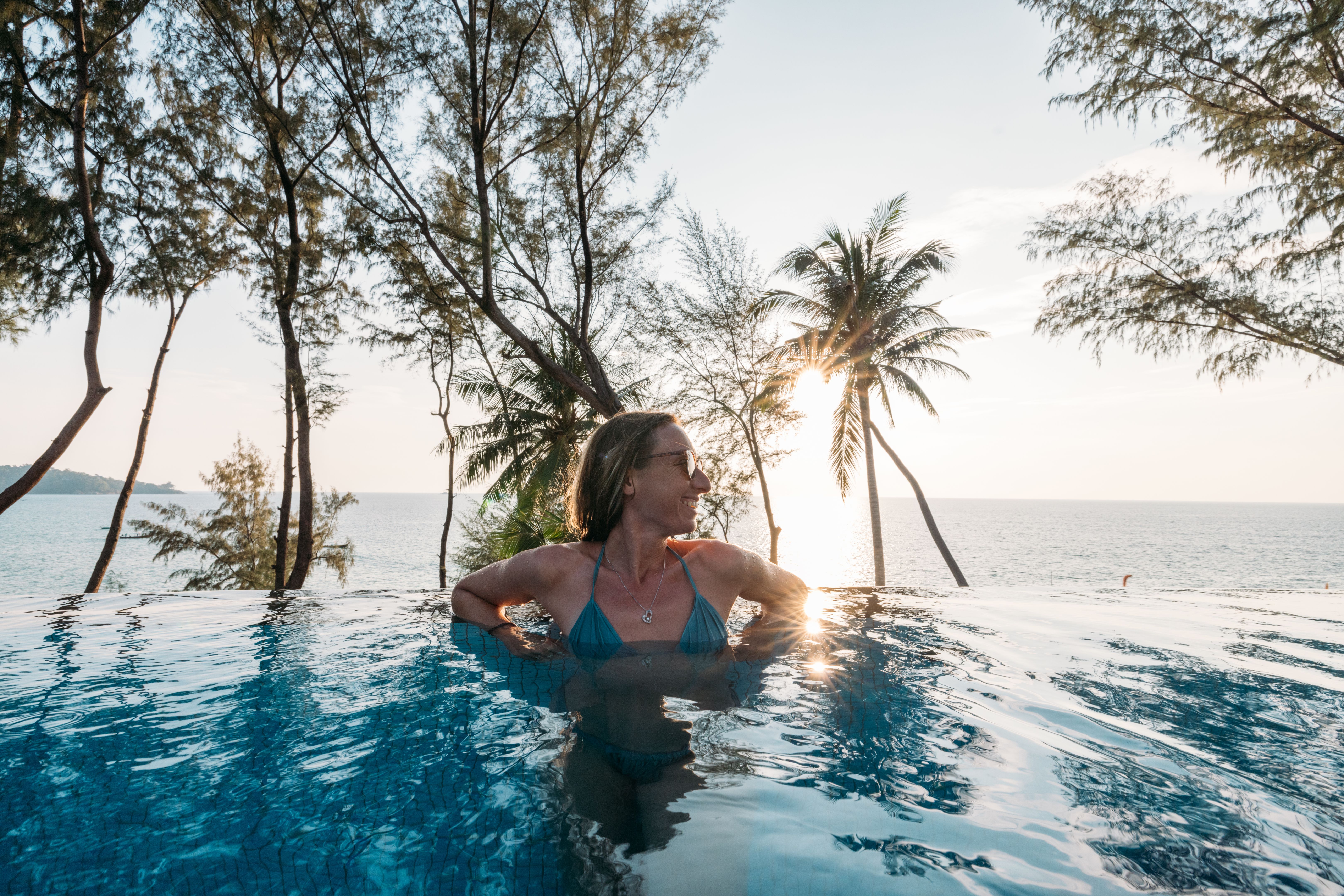 Woman Relaxing in Infinity Pool with Ocean View