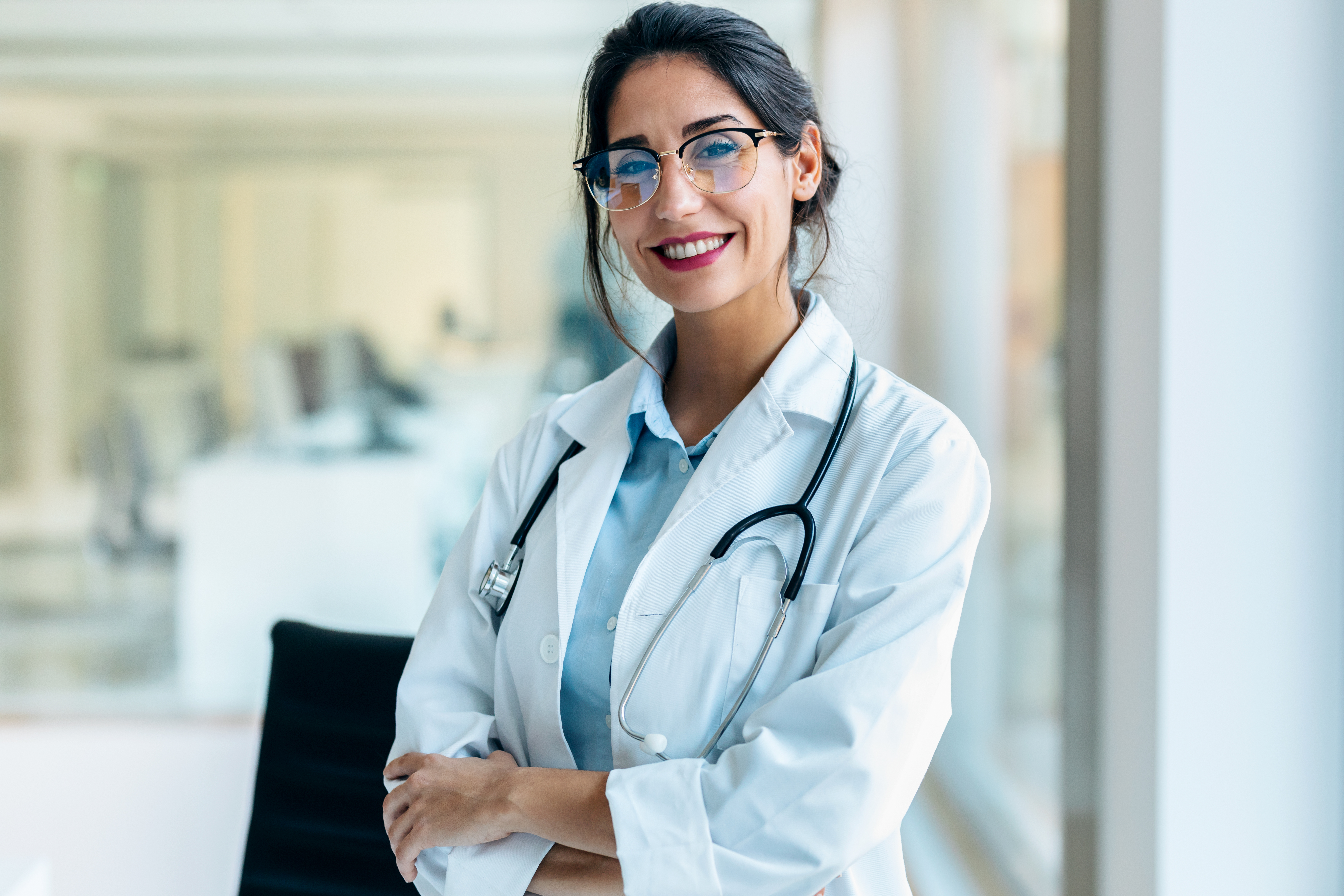 Smiling female doctor looking at camera in the medical consultation.