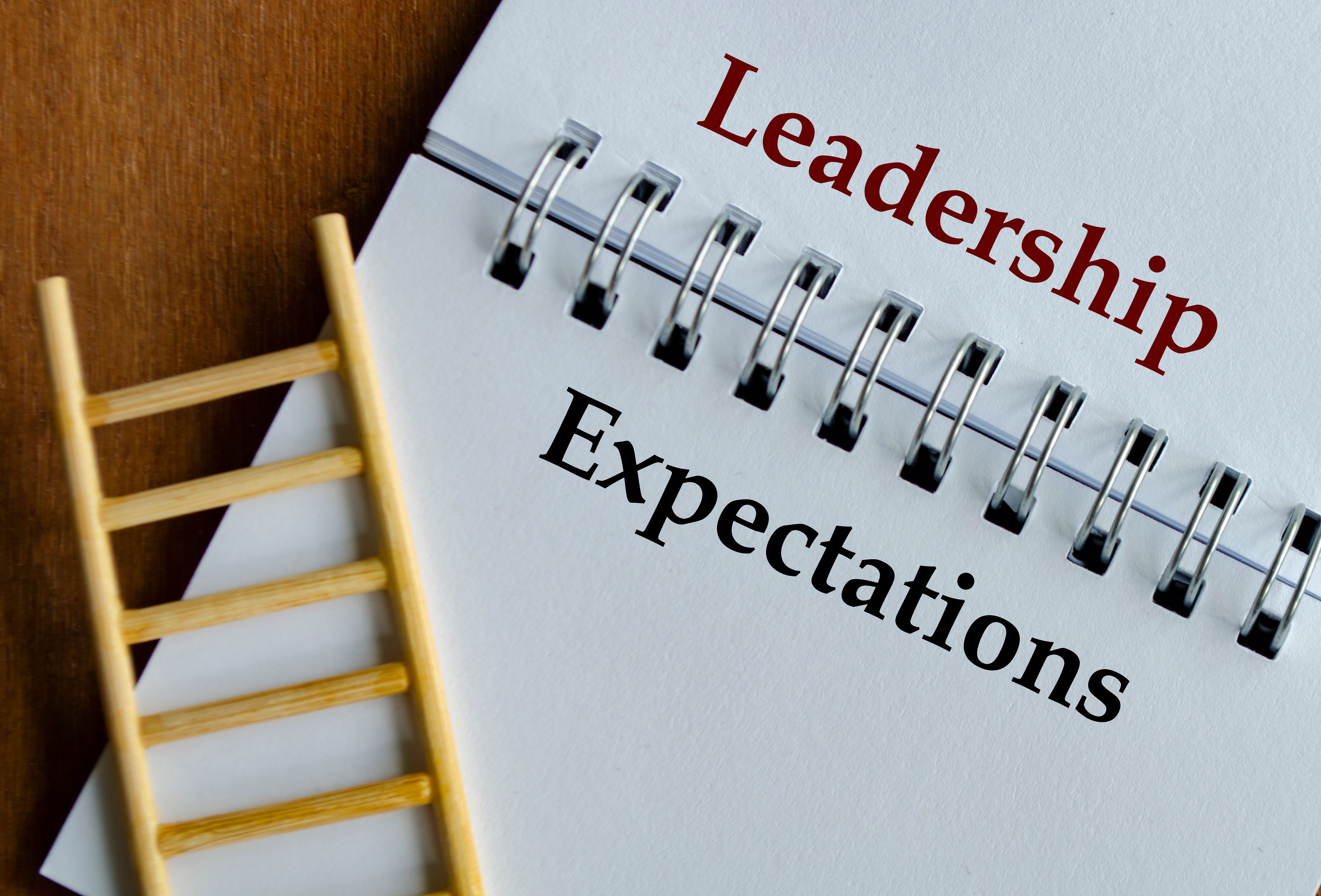 Notepad with clear text Leadership Expectations placed on desk with ladder visual support. Notepad with clear text Leadership Expectations placed on desk with ladder visual support.