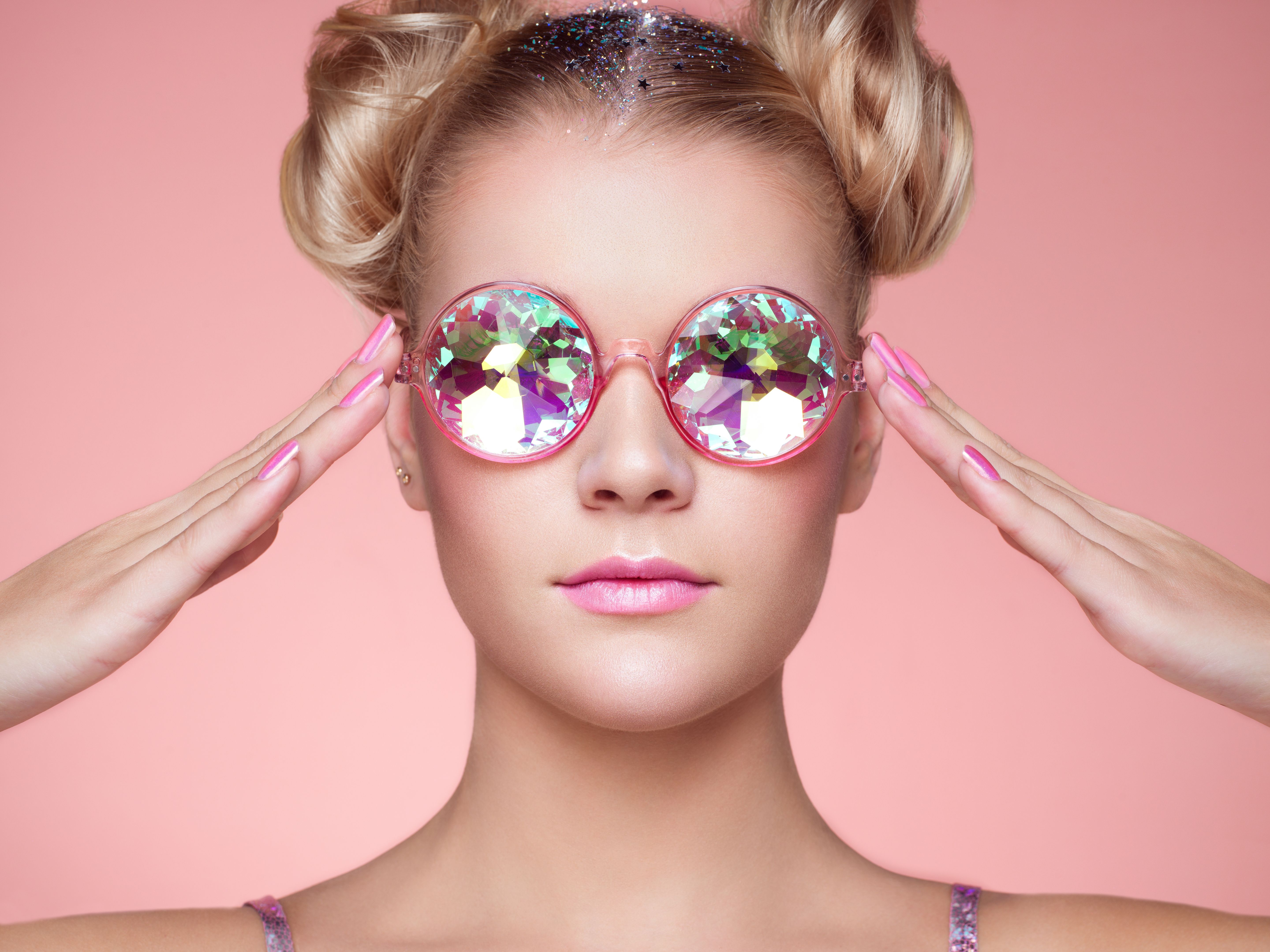 Portrait of beautiful young woman with colored glasses