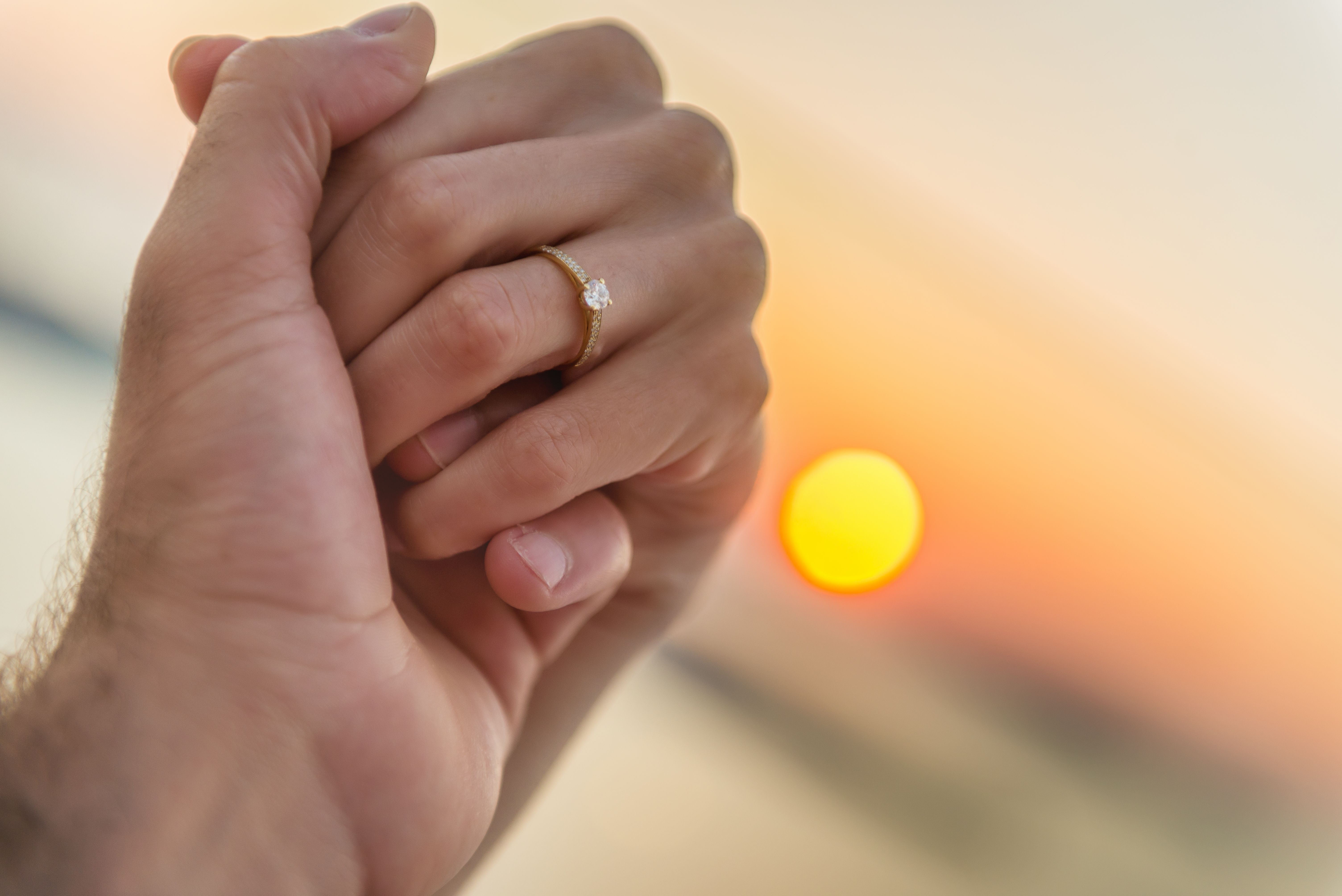 Couple holding hands during sunset