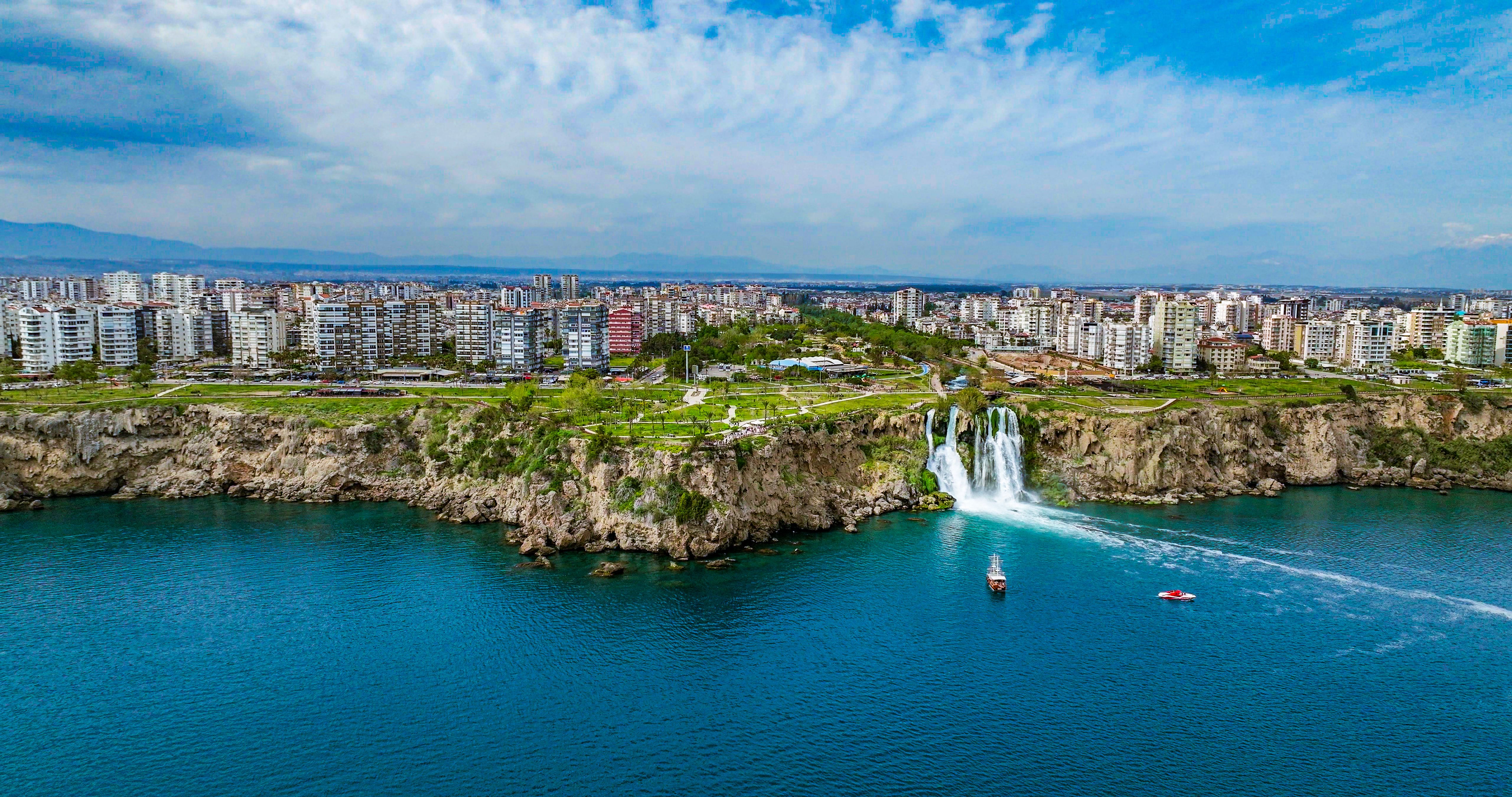 Duden waterfall dropping in Mediterranean Sea in Antalya, Lara Antalya in a bright sunny day, Lower Duden Waterfalls, high waterfall pouring into the sea, the waterfall in the city falls into the sea, turkey's famous tourism destination, the highest water