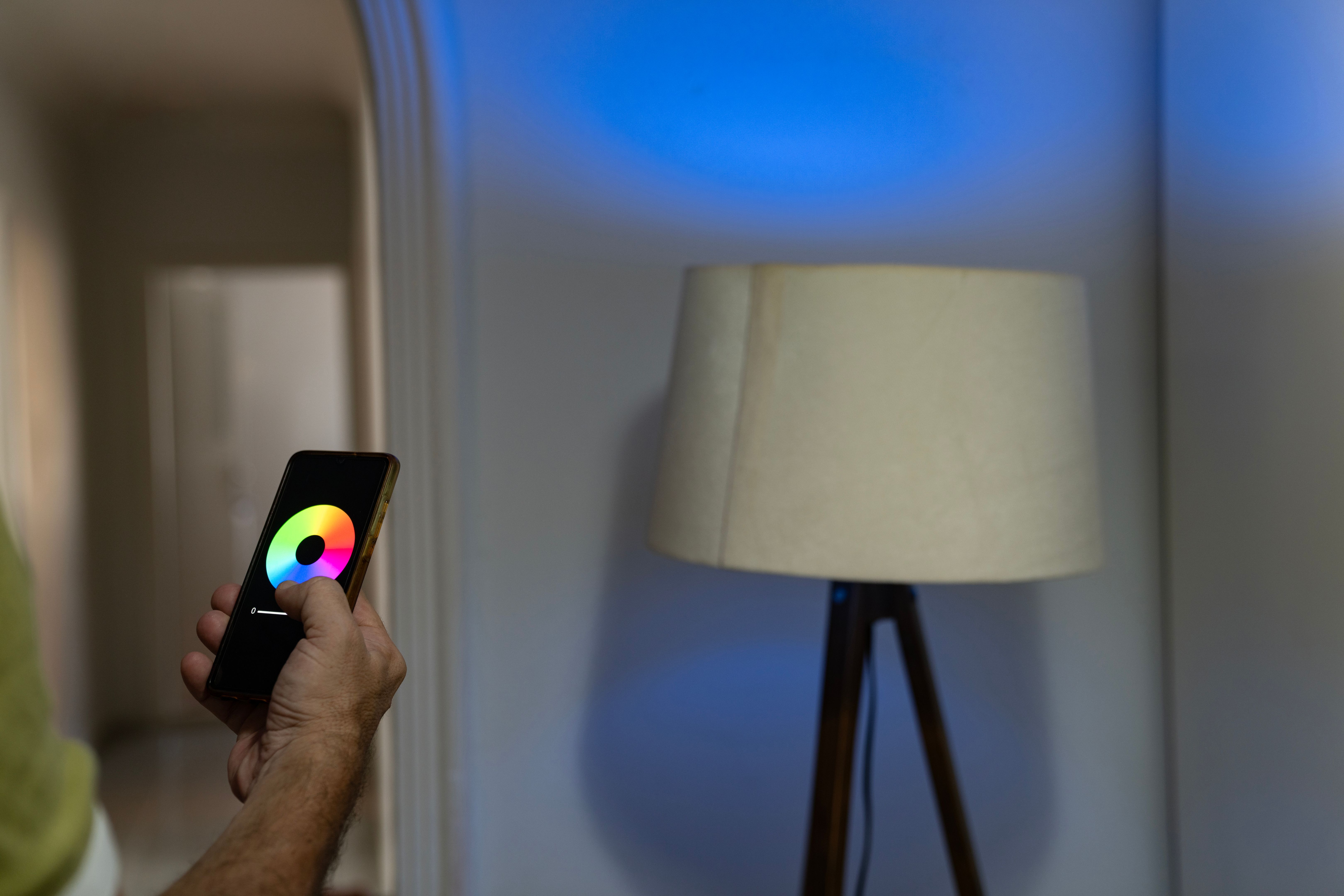 Photo of man setting floor lamp on mobile app