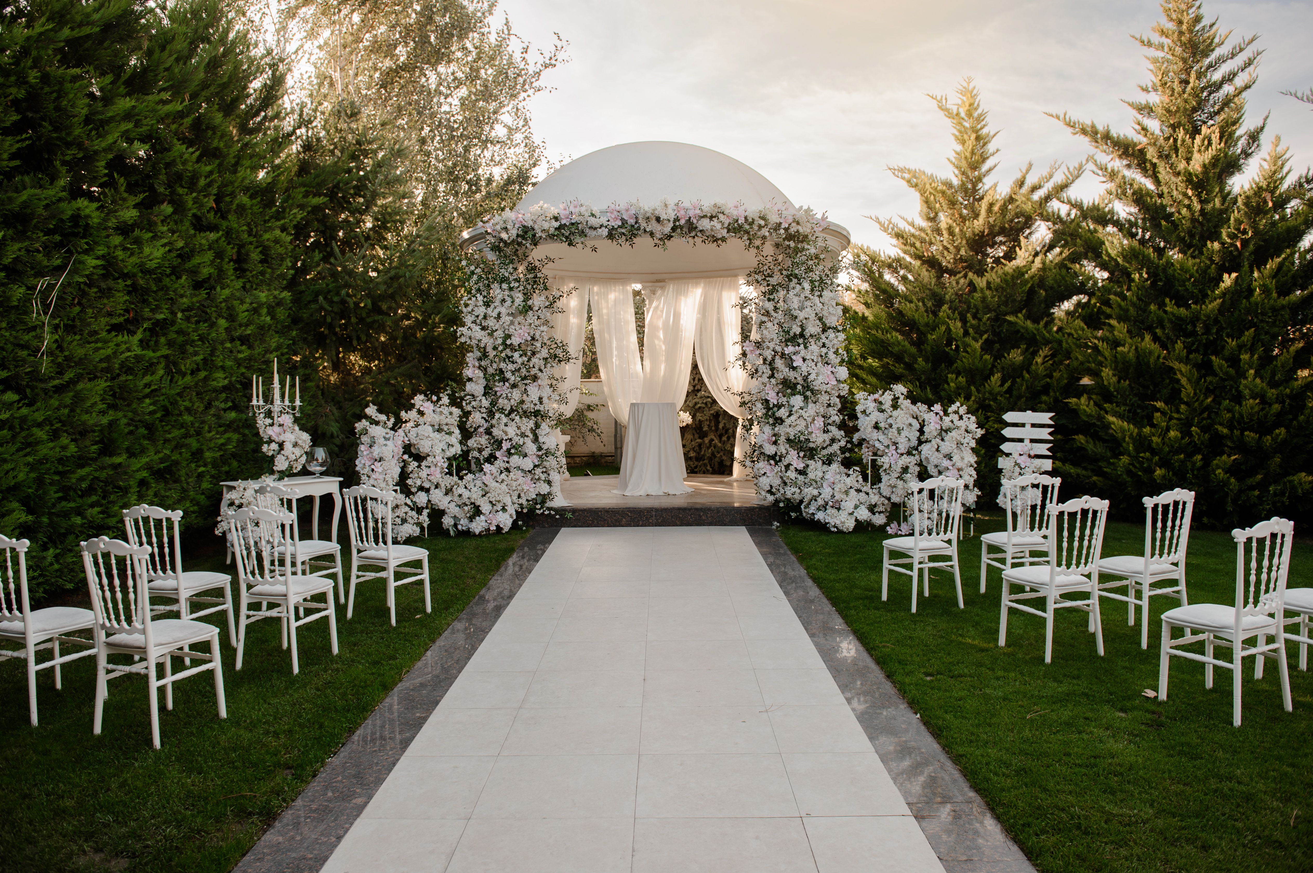 Outside place decorated with white flowers for the wedding ceremony.