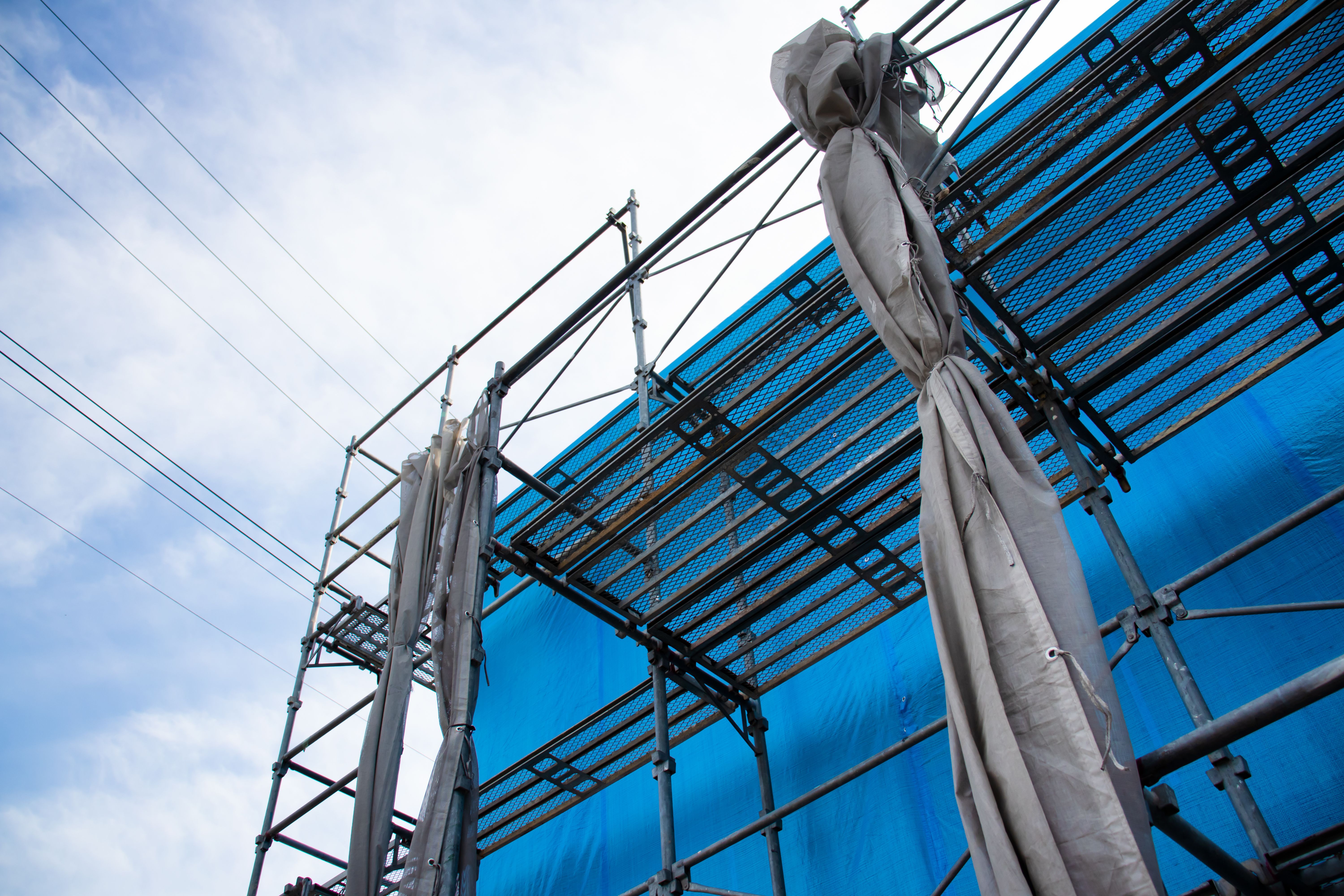 House under construction covered with blue tarp. House under construction covered with blue tarp.