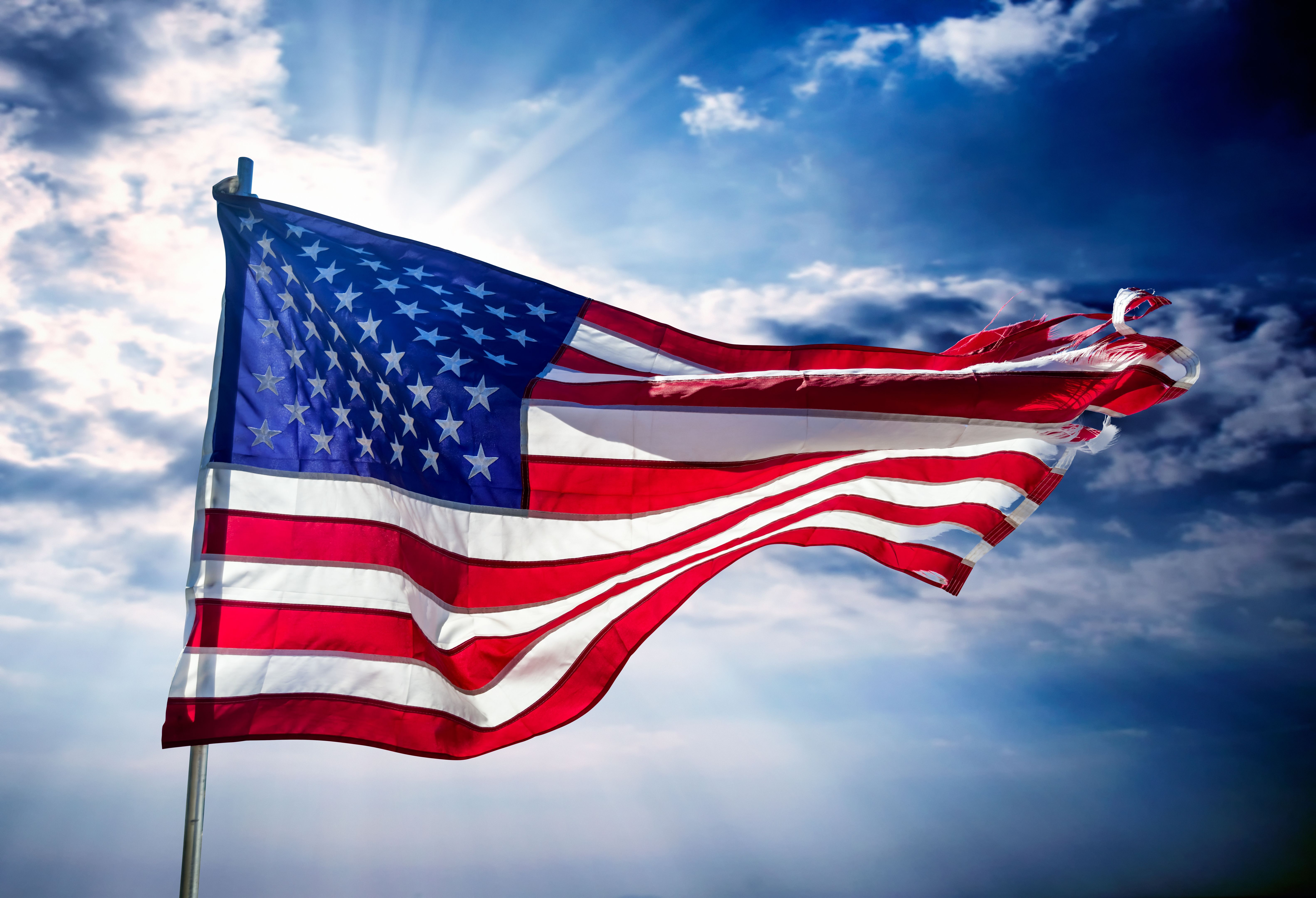 Close up American flag over dramatic sky