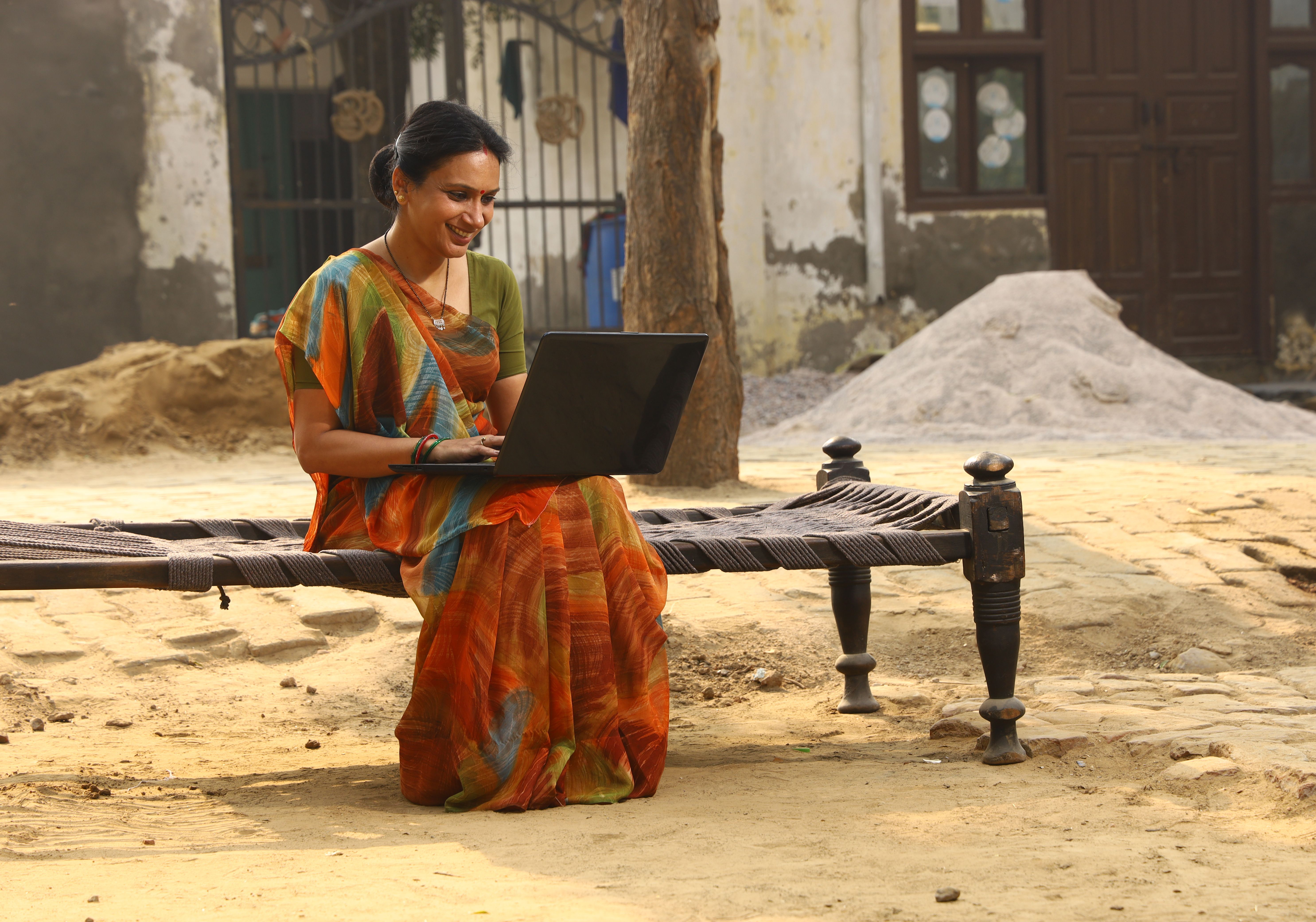 Indian Happy rural women working on laptop in village