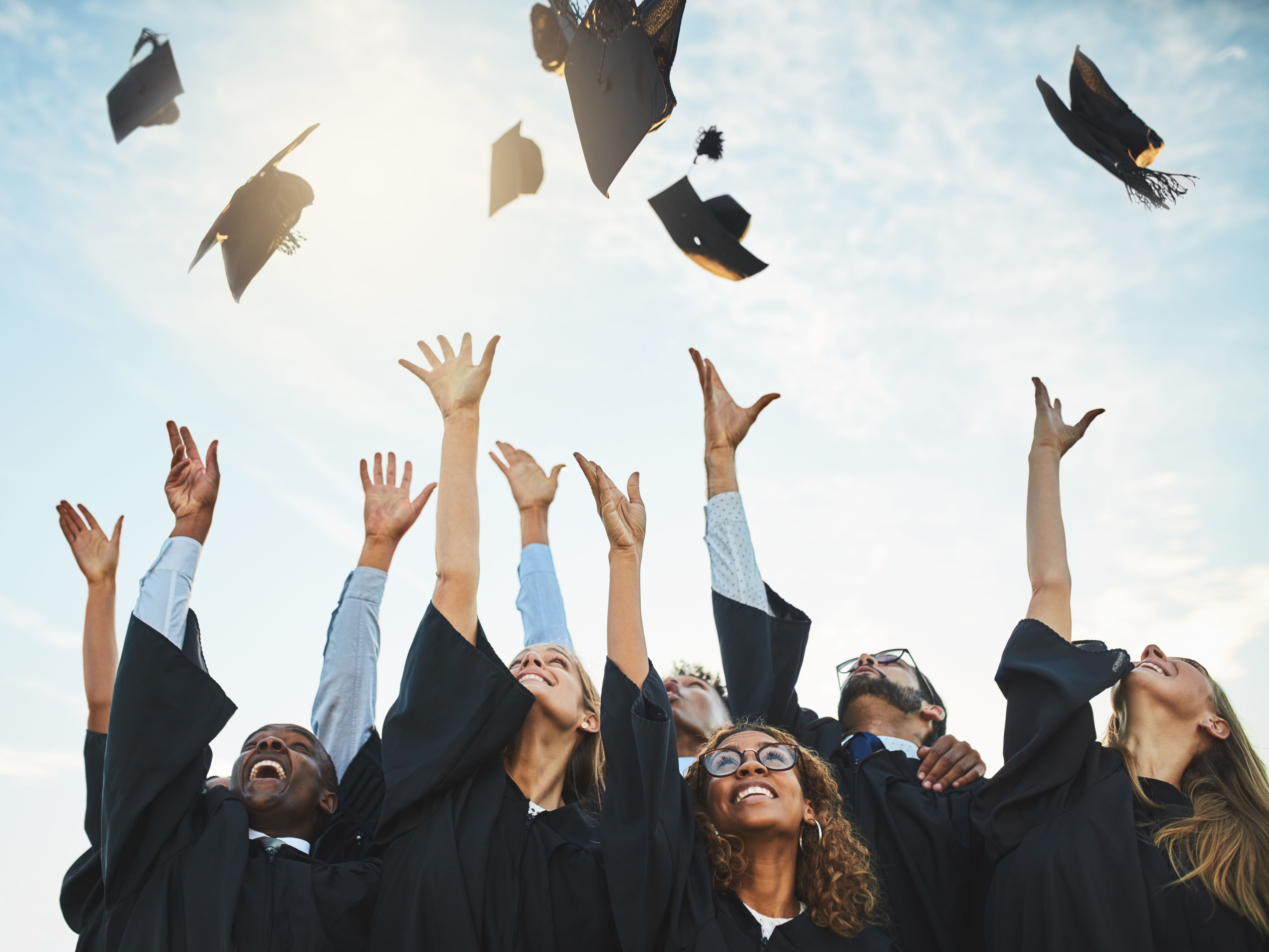 graduates throwing hats