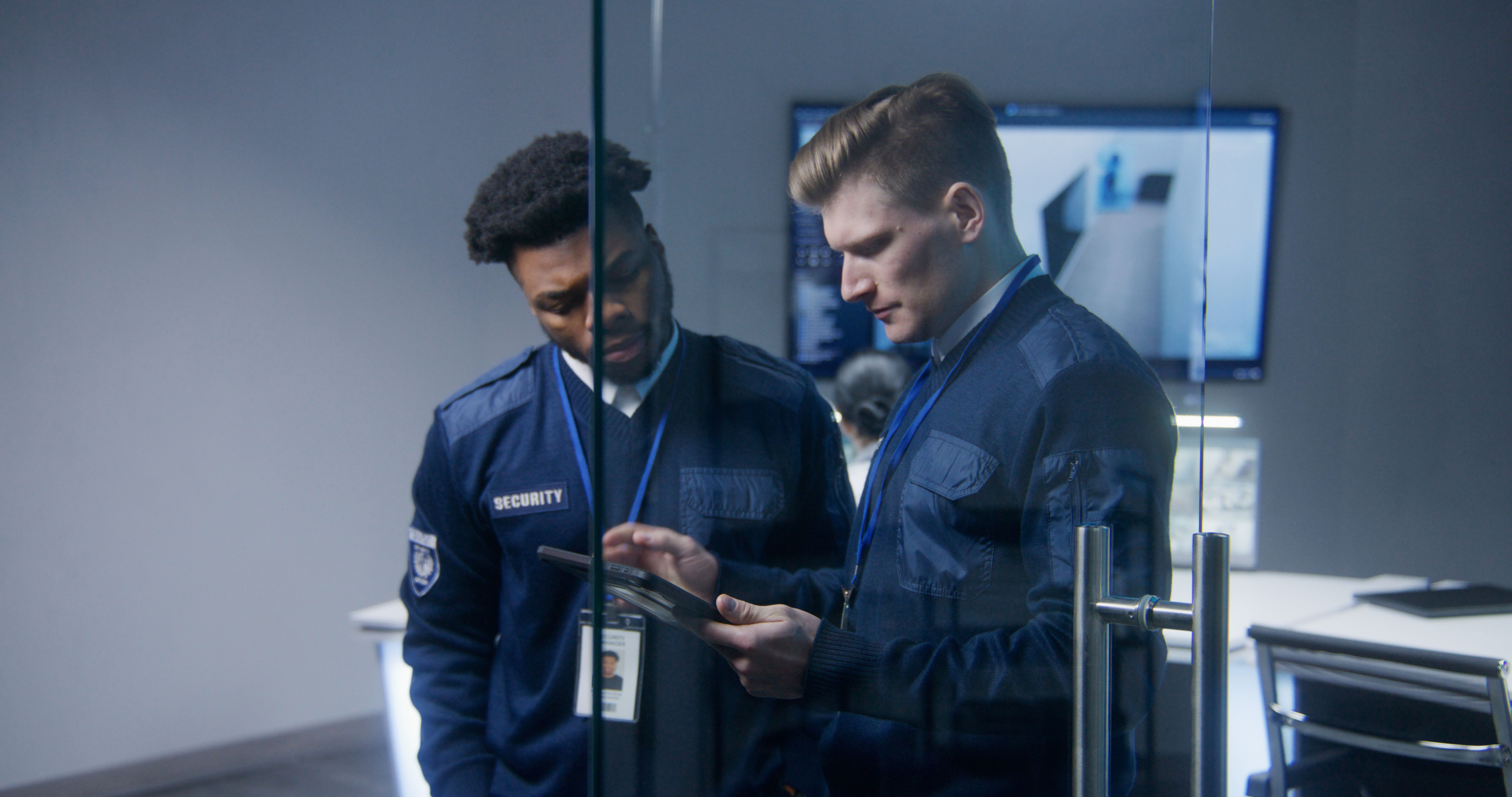 Multi ethnic workers in security control center