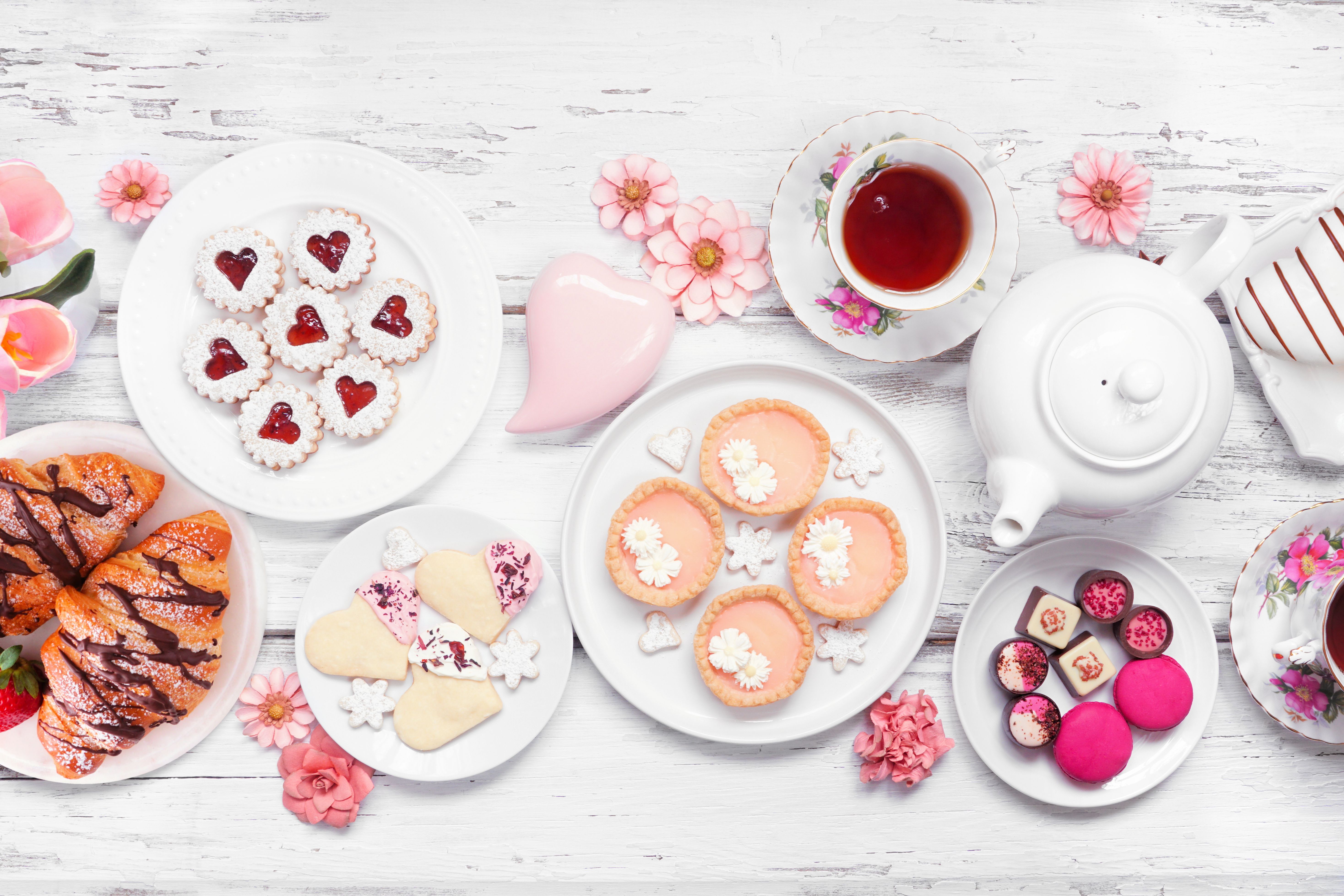 Mother's Day tea table scene over a white wood background