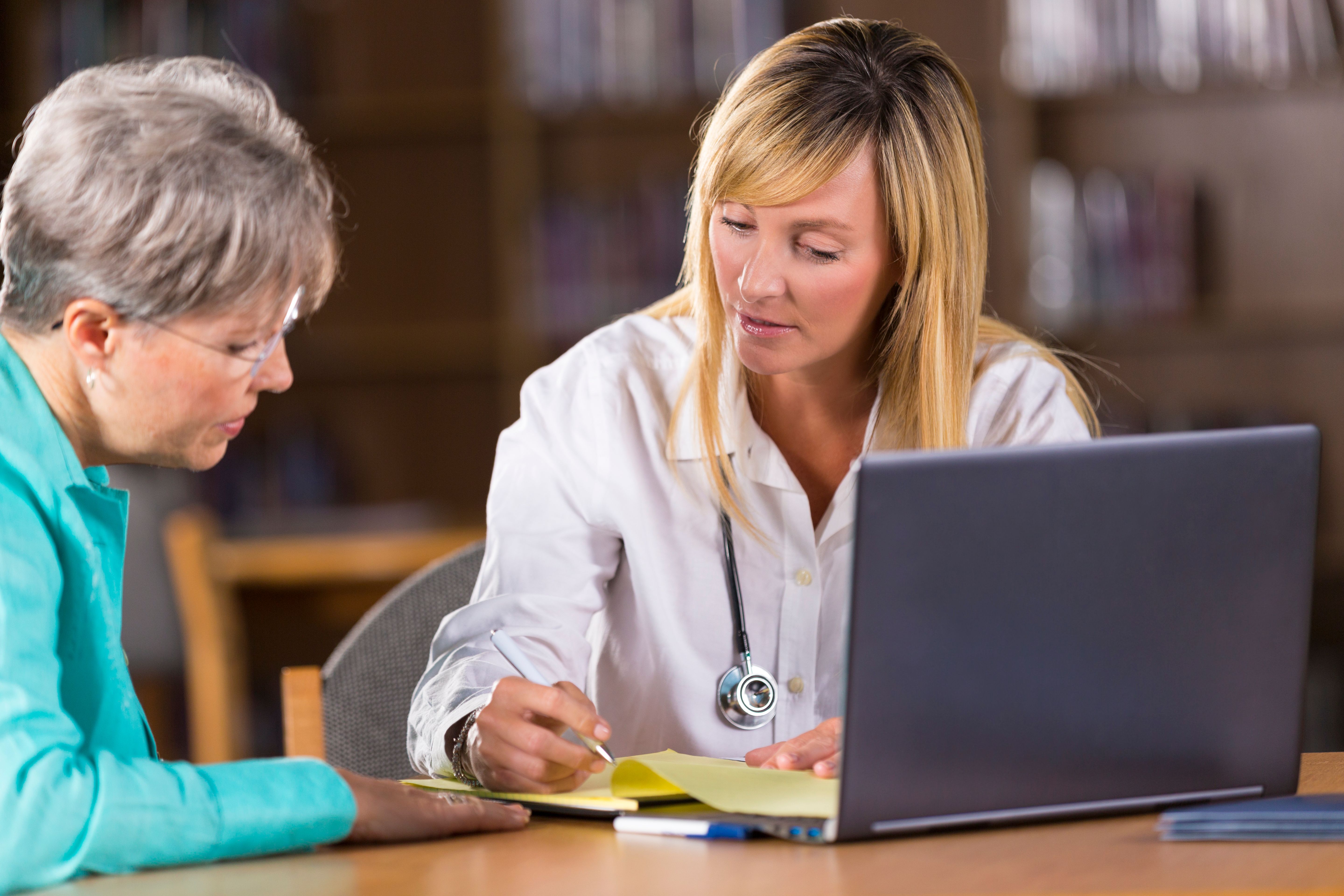 Female doctor discussing test results with senior patient