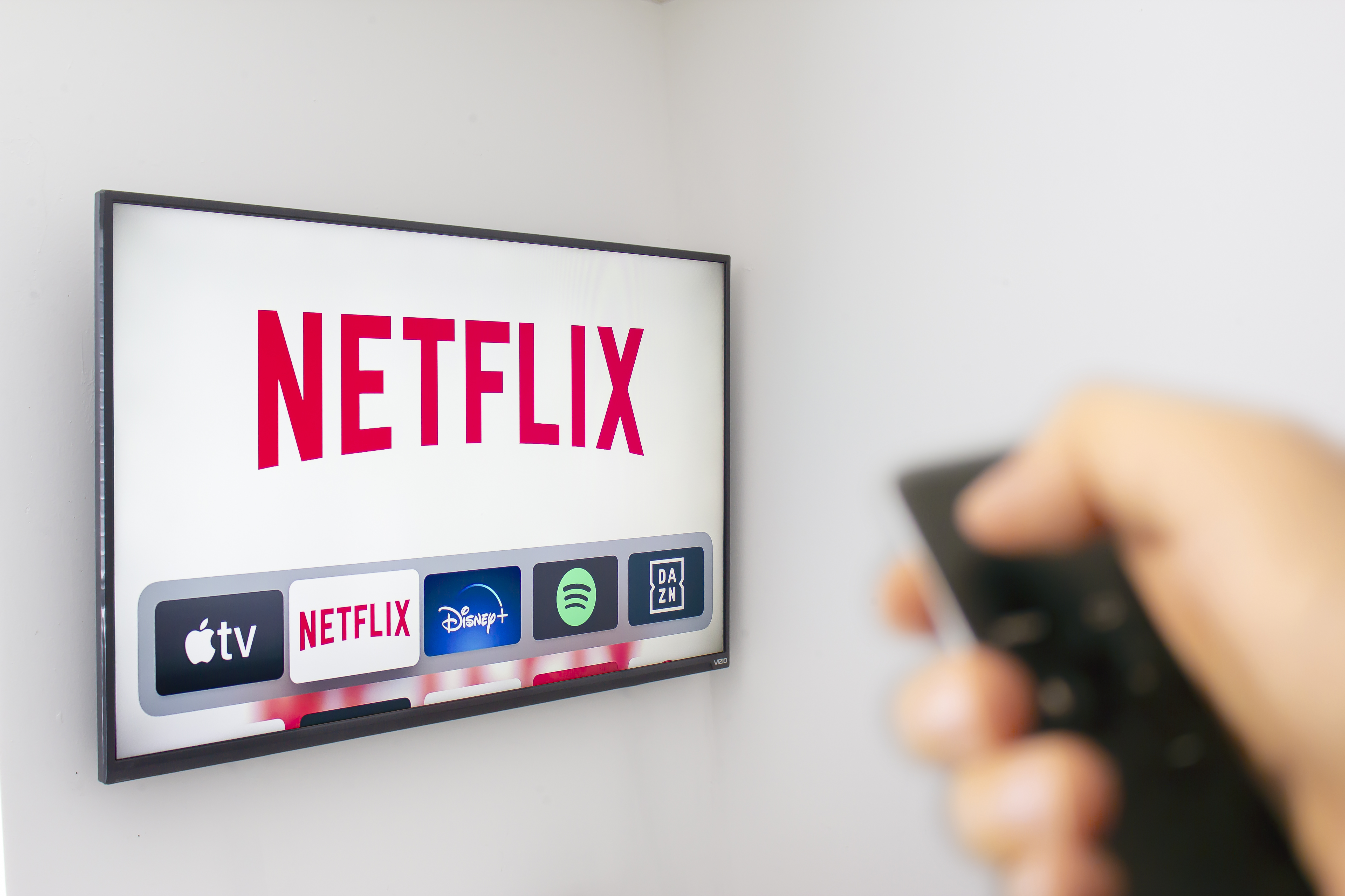 A Person holds an Apple TV remote using the new Netflix app with a hand. Netflix dominates Golden Globe Nominations. Illustrative A Person holds an Apple TV remote using the new Netflix app with a hand. Netflix dominates Golden Globe Nominations. Illustrative