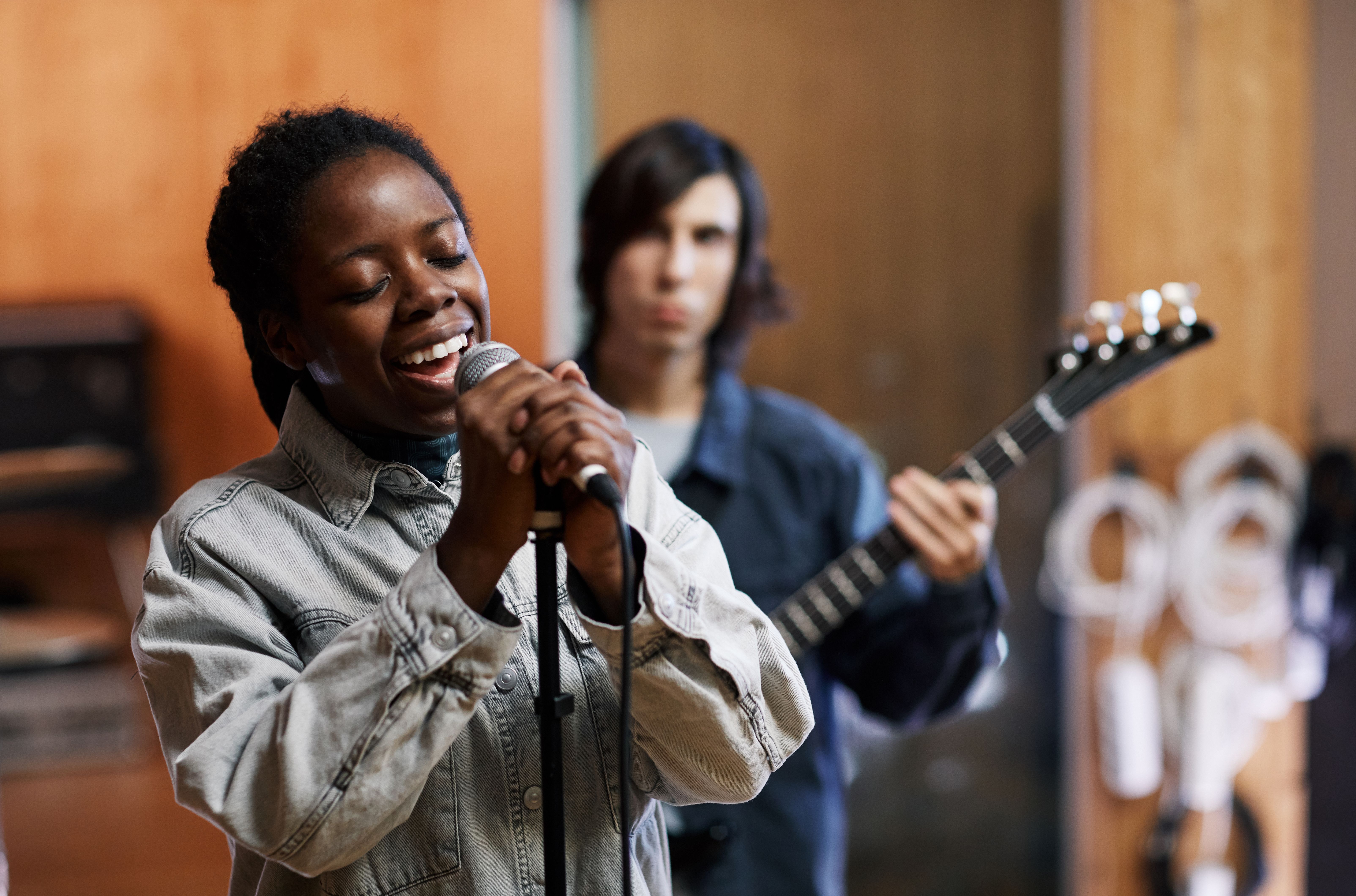 Young Woman Singing with Band in Studio Young Woman Singing with Band in Studio