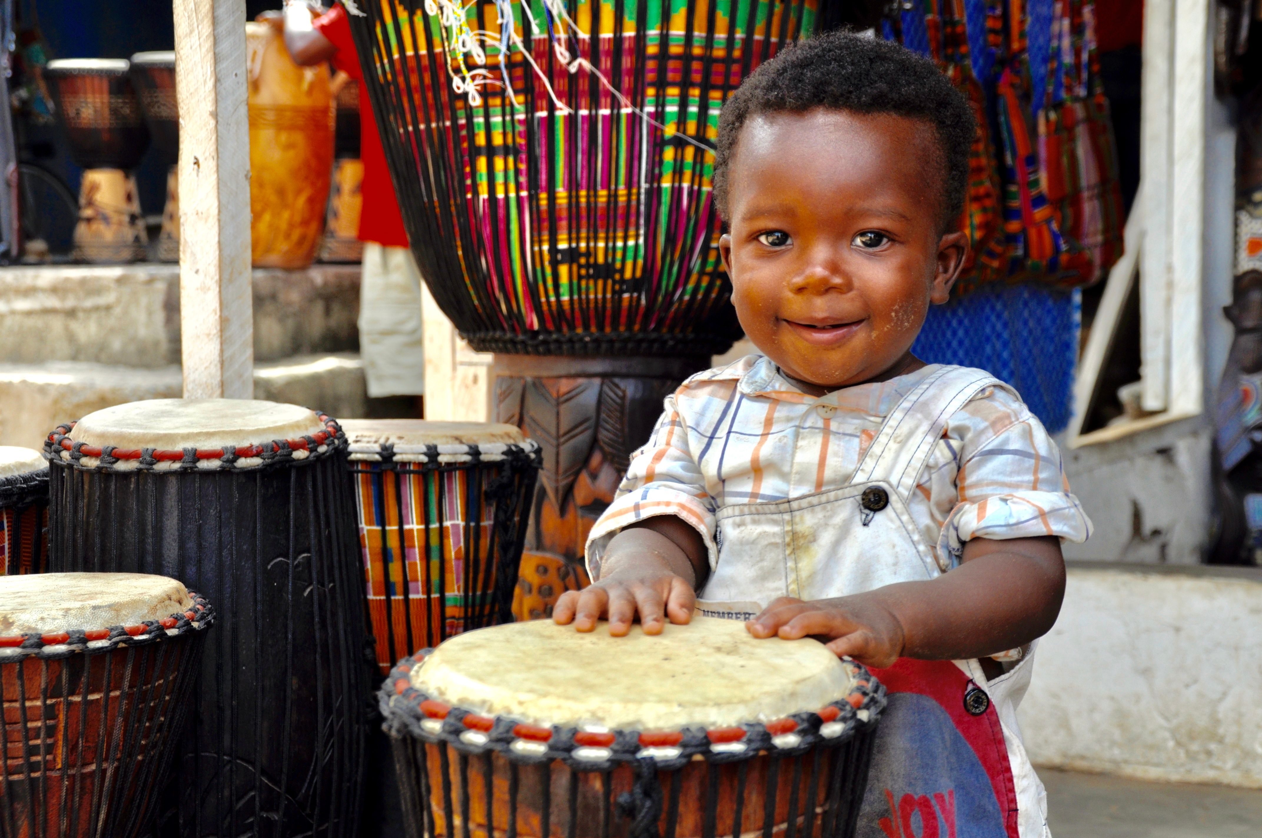 Portrait Of Smiling Boy Playing Drum