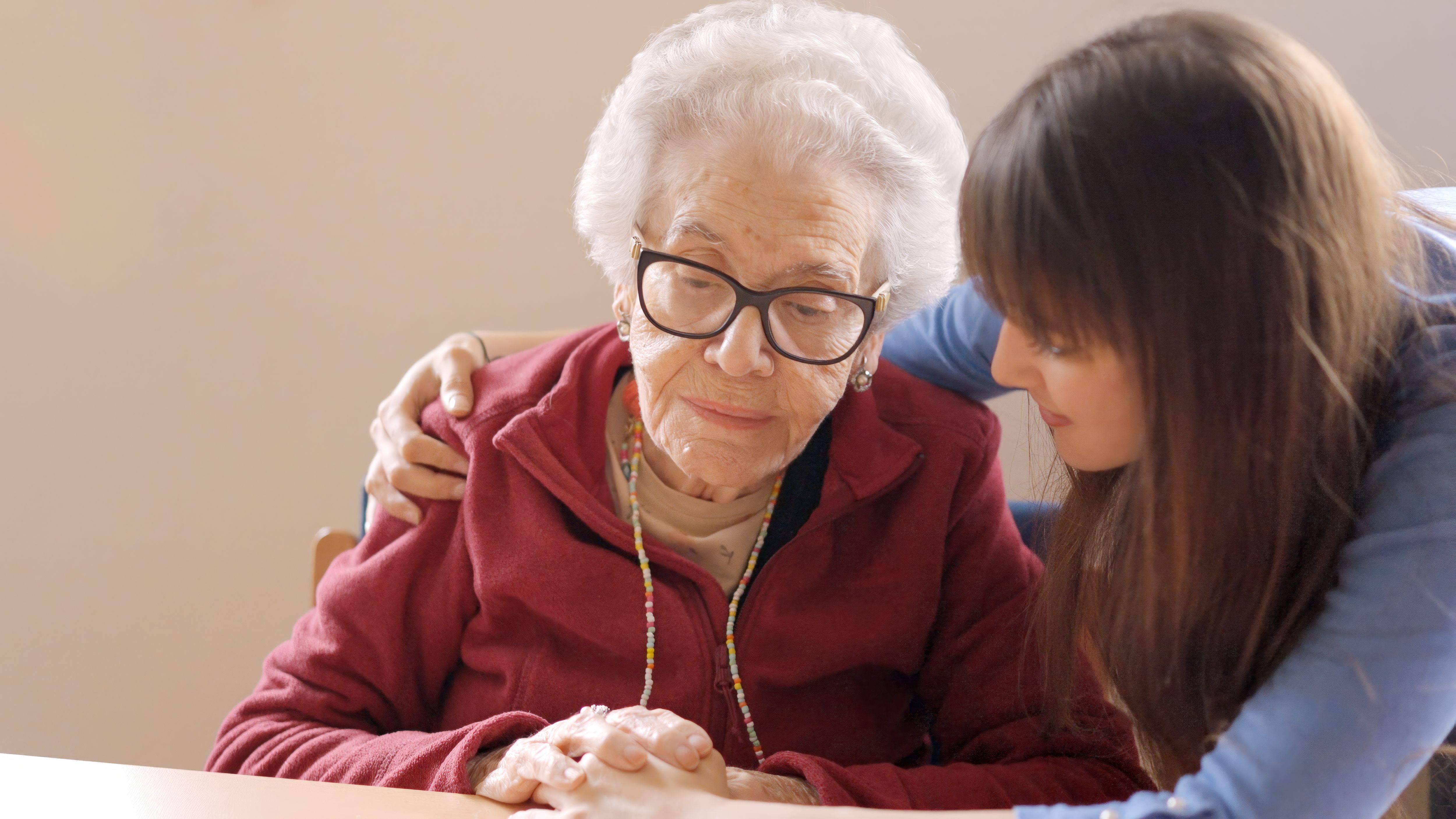 Granddaughter cheers up her sad grandmother in a nursing home Granddaughter cheers up her sad grandmother in a nursing home