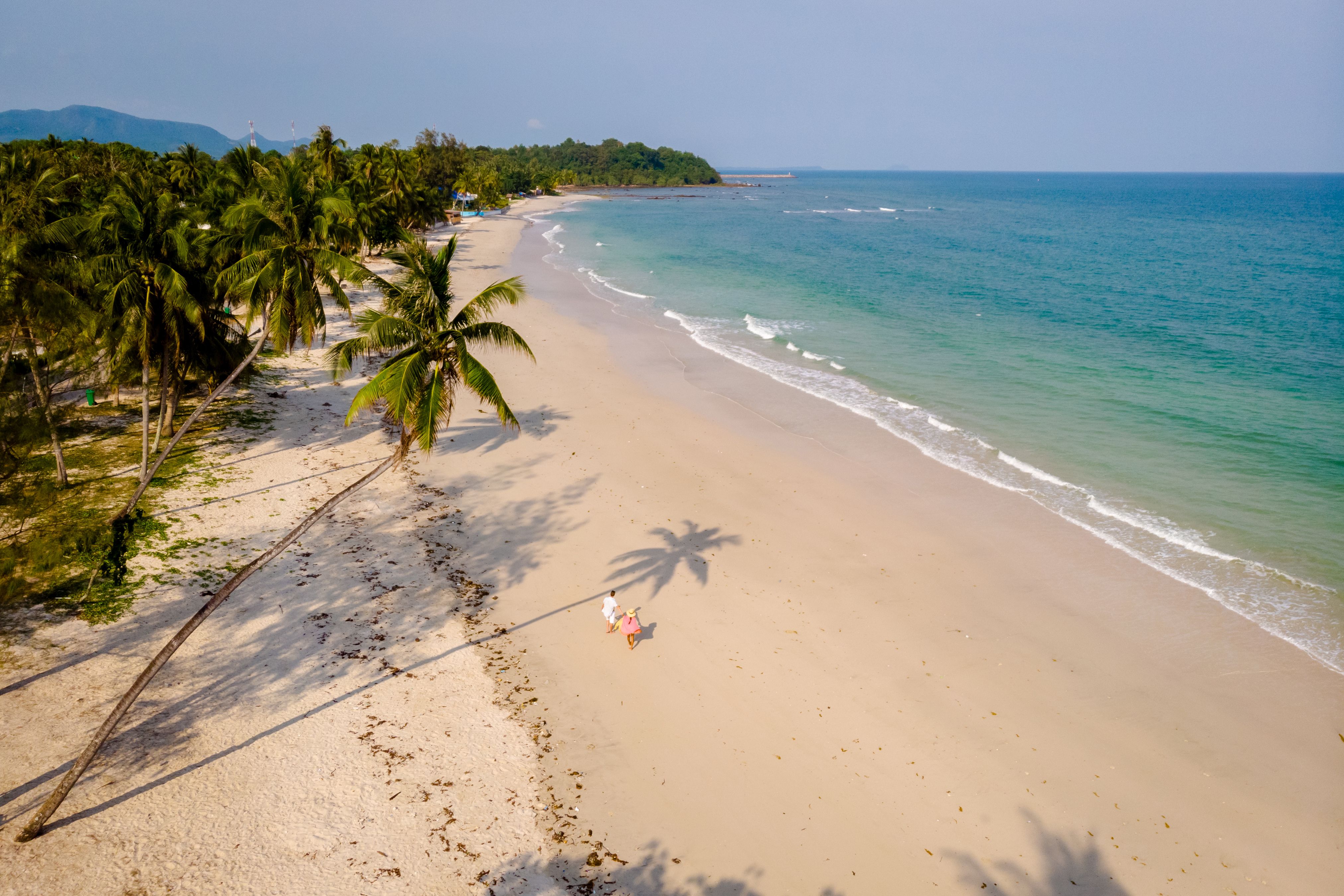 couple on vacation in Thailand, Chumpon province, white tropical beach with palm trees